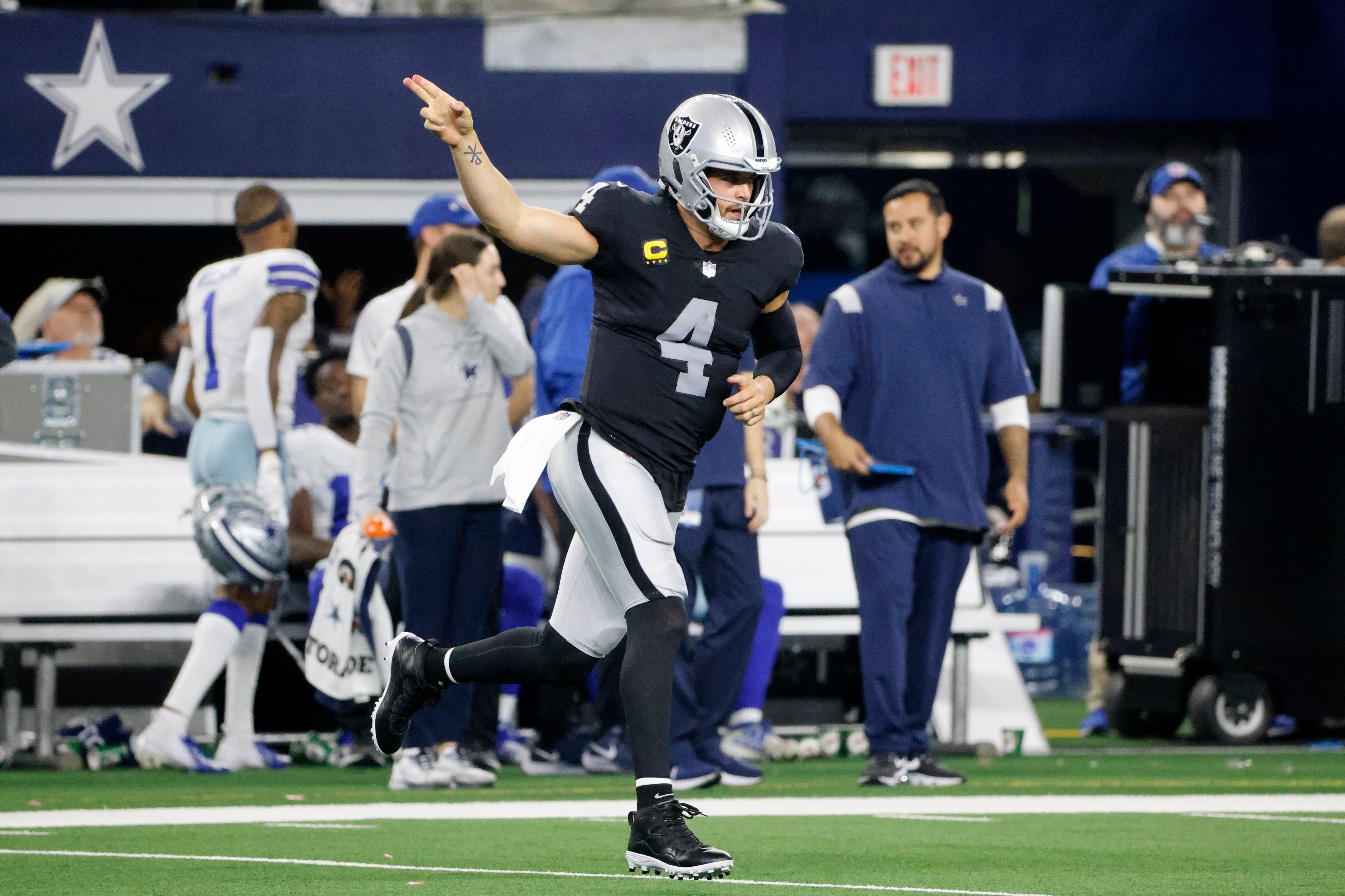 Las Vegas Raiders quarterback Derek Carr celebrates running the ball for a first down in the second half of an NFL football game against the Dallas Cowboys in Arlington, Texas, Thursday, Nov. 25, 2021. (AP Photo/Michael Ainsworth)