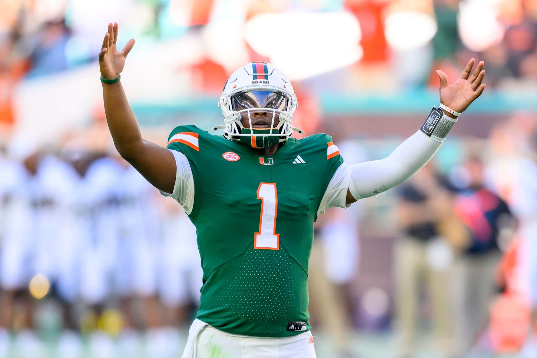 MIAMI GARDENS, FL - NOVEMBER 23: Miami Quarterback Cam Ward (1) raises his arms as he celebrates running back Jordan Lyle (not shown) scoring a touchdown  during the college football game between the Wake Forest Deacon Demons and the University of Miami Hurricanes on November 23, 2024 at the Hard Rock Stadium in Miami Gardens, FL. (Photo by Doug Murray/Icon Sportswire via Getty Images)