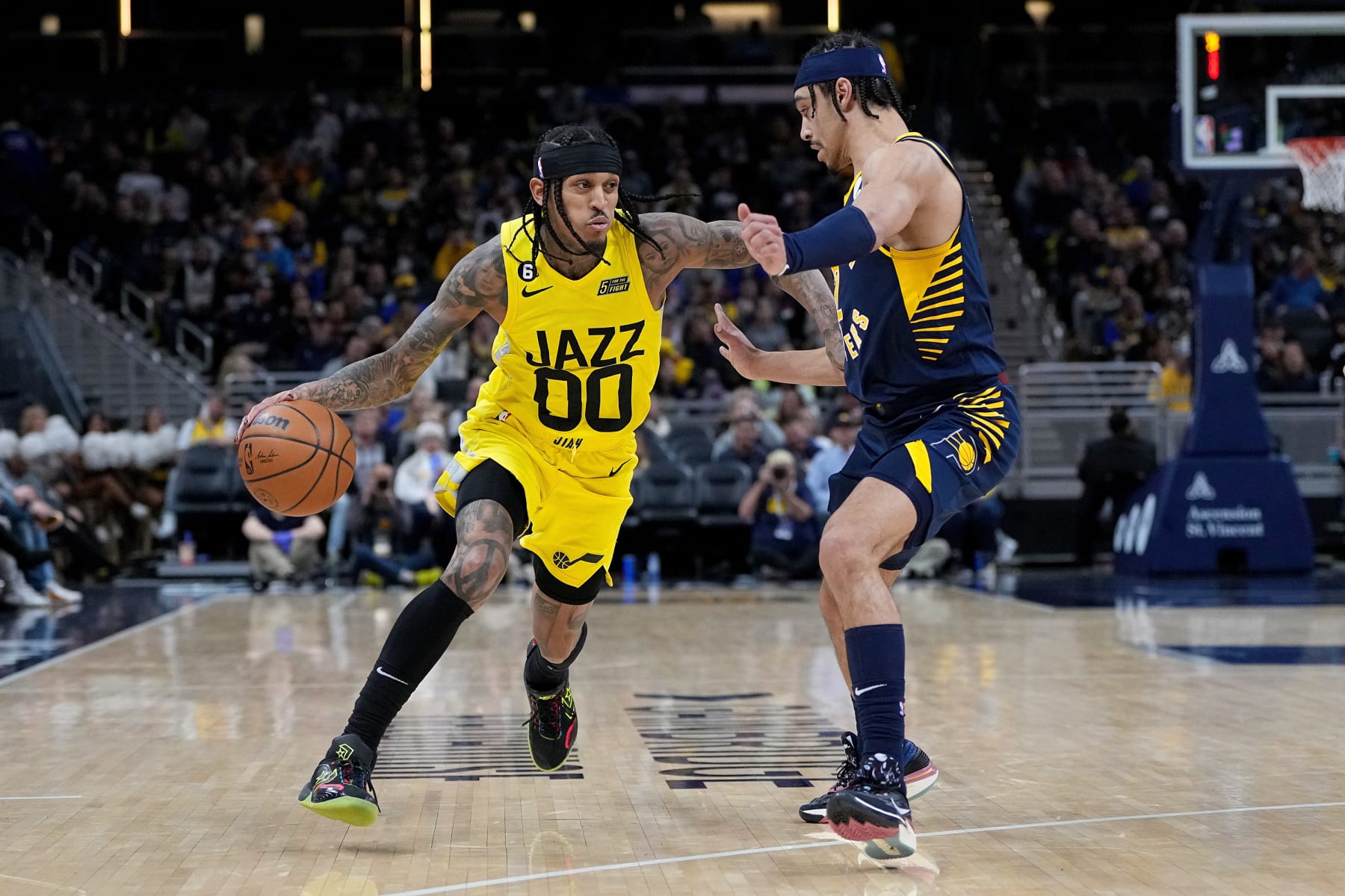 INDIANAPOLIS, INDIANA - FEBRUARY 13: Jordan Clarkson #00 of the Utah Jazz dribbles the ball while being guarded by Andrew Nembhard #2 of the Indiana Pacers in the third quarter at Gainbridge Fieldhouse on February 13, 2023 in Indianapolis, Indiana. NOTE TO USER: User expressly acknowledges and agrees that, by downloading and or using this photograph, User is consenting to the terms and conditions of the Getty Images License Agreement. (Photo by Dylan Buell/Getty Images)