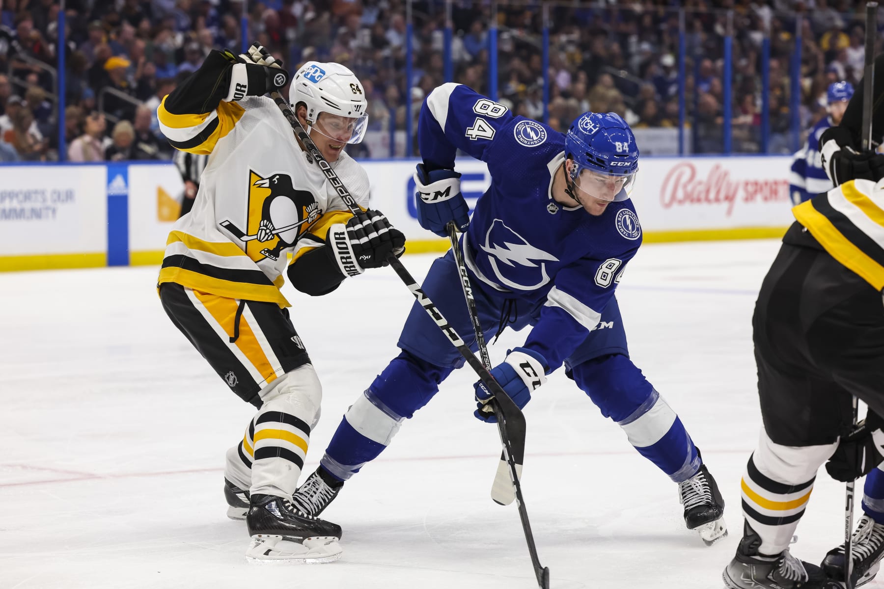 TAMPA, FL - MARCH 2: Tanner Jeannot #84 of the Tampa Bay Lightning against Mikael Granlund #64 of the Pittsburgh Penguins during the third period at Amalie Arena on March 2, 2023 in Tampa, Florida. (Photo by Mark LoMoglio/NHLI via Getty Images)