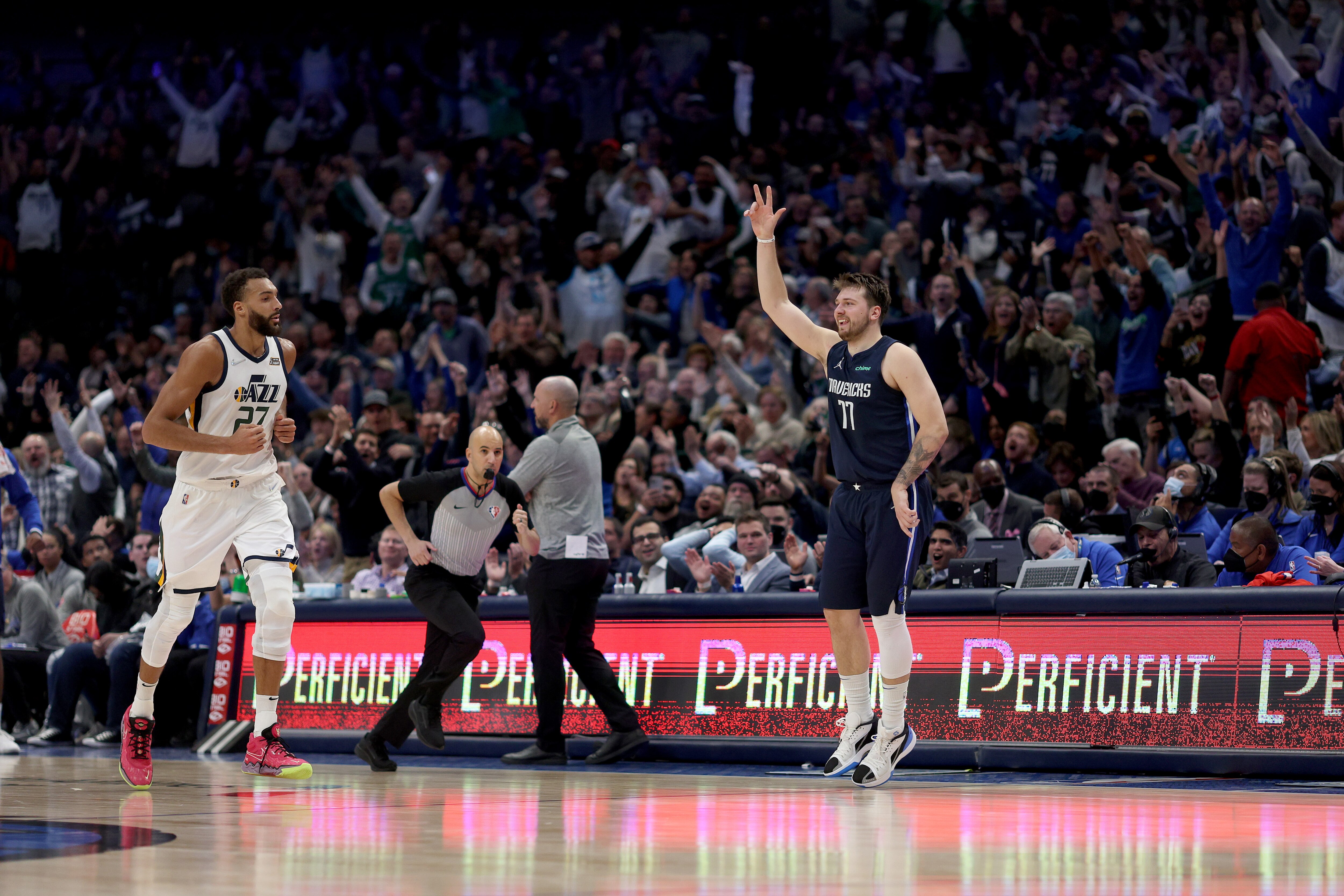 DALLAS, TEXAS - MARCH 07: Luka Doncic #77 of the Dallas Mavericks shoots a three-point shot against Rudy Gobert #27 of the Utah Jazz in the second half at American Airlines Center on March 07, 2022 in Dallas, Texas. NOTE TO USER: User expressly acknowledges and agrees that, by downloading and or using this photograph, User is consenting to the terms and conditions of the Getty Images License Agreement. (Photo by Tom Pennington/Getty Images)