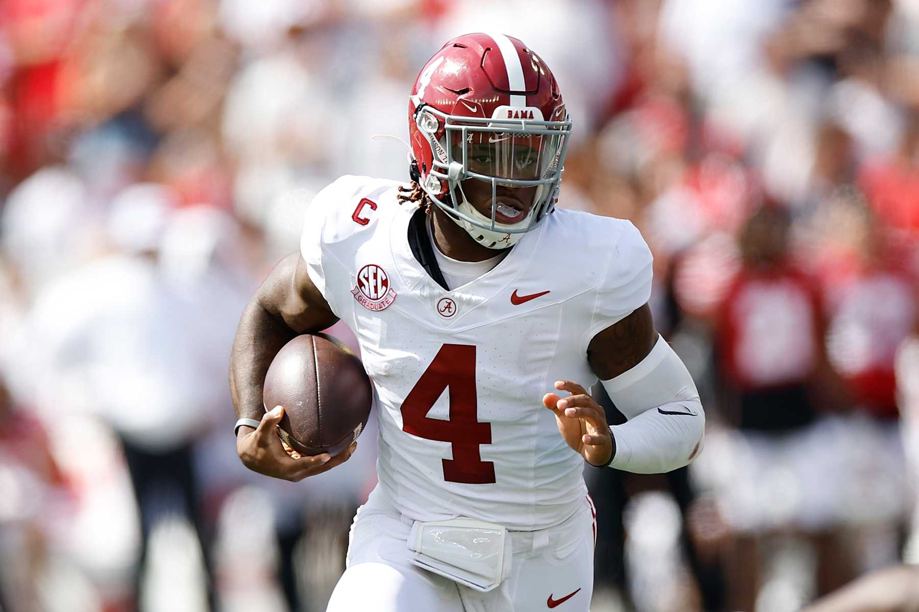 MADISON, WISCONSIN - SEPTEMBER 14: Jalen Milroe #4 of the Alabama Crimson Tide carries the ball in the first quarter against the Wisconsin Badgers at Camp Randall Stadium on September 14, 2024 in Madison, Wisconsin. (Photo by John Fisher/Getty Images)
