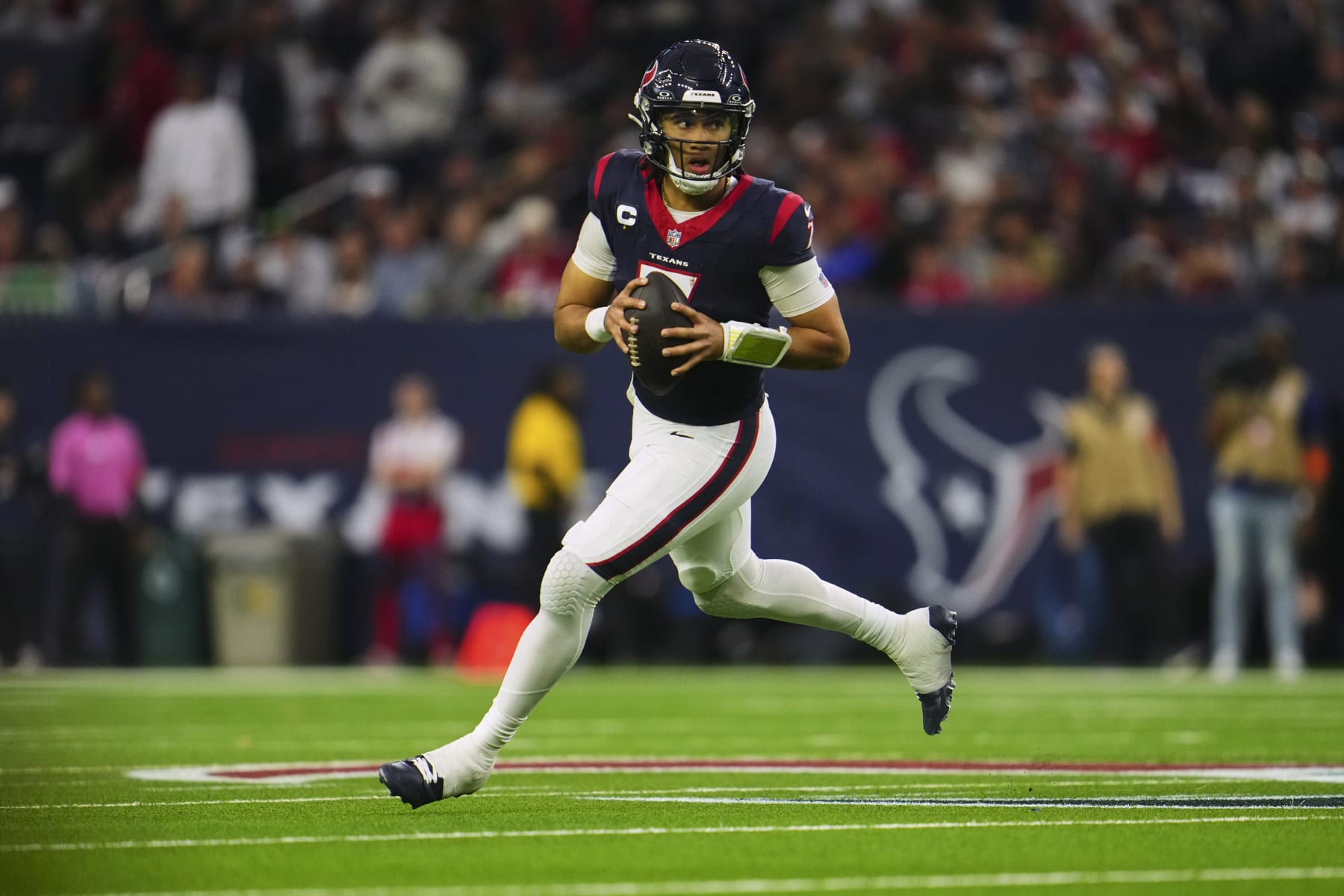 HOUSTON, TX - JANUARY 13: C.J. Stroud #7 of the Houston Texans drops back to pass against the Cleveland Browns during the first half of the AFC Wild Card playoff game at NRG Stadium on January 13, 2024 in Houston, Texas. (Photo by Cooper Neill/Getty Images)