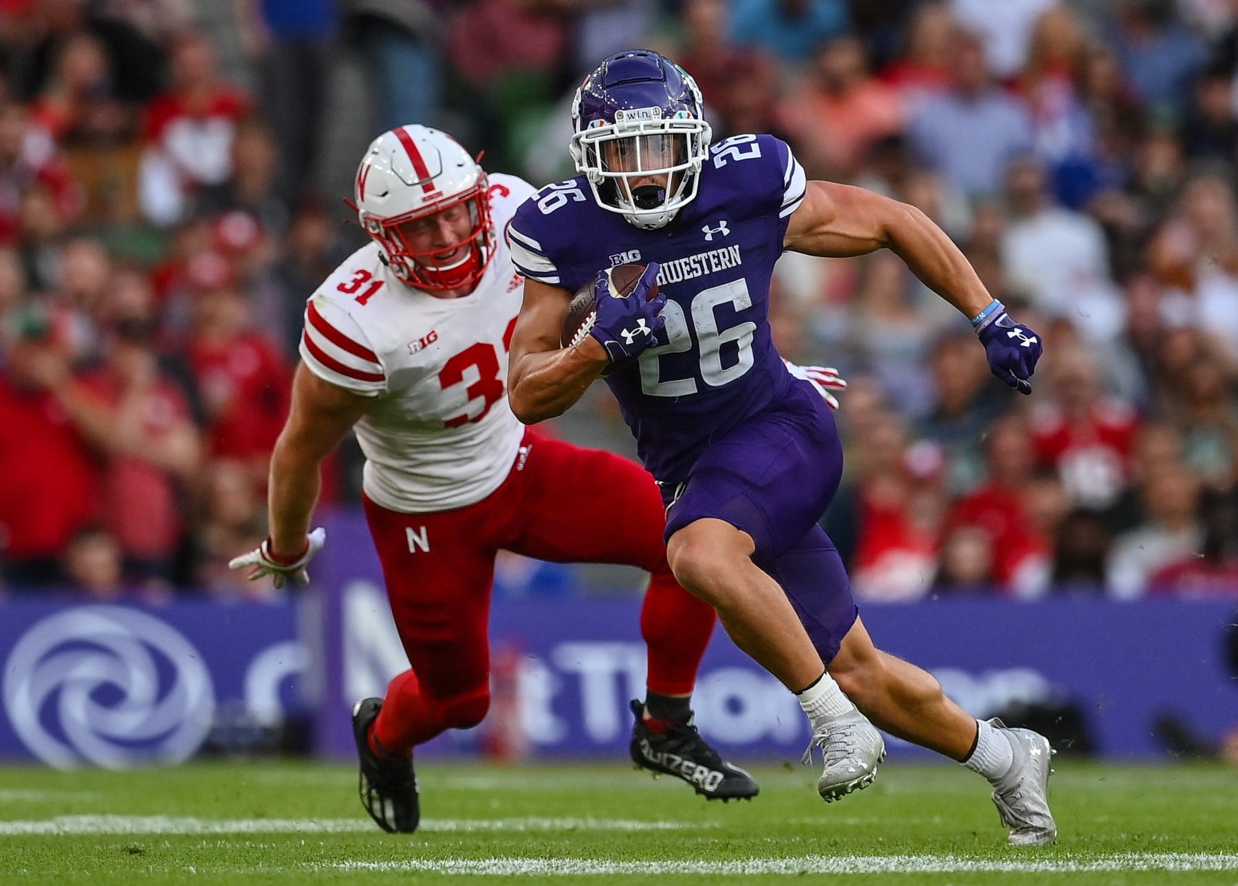 Dublin , Ireland - 27 August 2022; Northwestern Wildcats running back Evan Hull races clear of Nebraska Cornhuskers nickel back Chris Kolarevic during the Aer Lingus College Football Classic 2022 match between Northwestern Wildcats and Nebraska Cornhuskers at Aviva Stadium in Dublin. (Photo By Brendan Moran/Sportsfile via Getty Images)