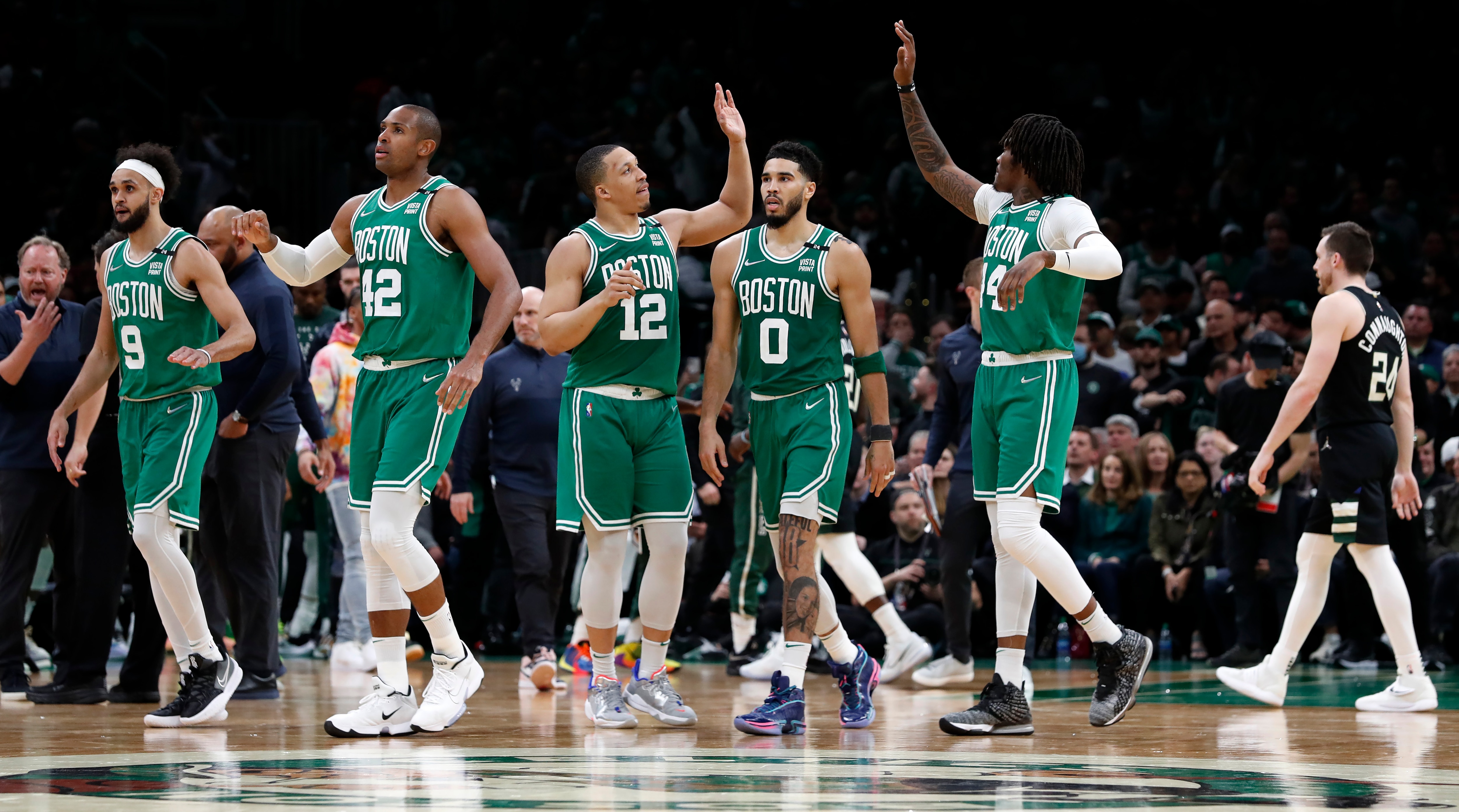 Boston - May 3: The Celtics Derrick White, Al Horford, Grant Williams, Jayson Tatum and Robert Williams head for the bench as Milwaukee calls a timeout late in the fourth quarter and the reserves would come onto the floor to finish off the blowout Boston victory. The Bucks Pat Connaughton is in the background at far right. The Boston Celtics host the Milwaukee Bucks in Game 2 of the Eastern Conference semi-finals between the Celtics and Bucks on May 3, 2022 at TD Garden in Boston. (Photo by Jim Davis/The Boston Globe via Getty Images)