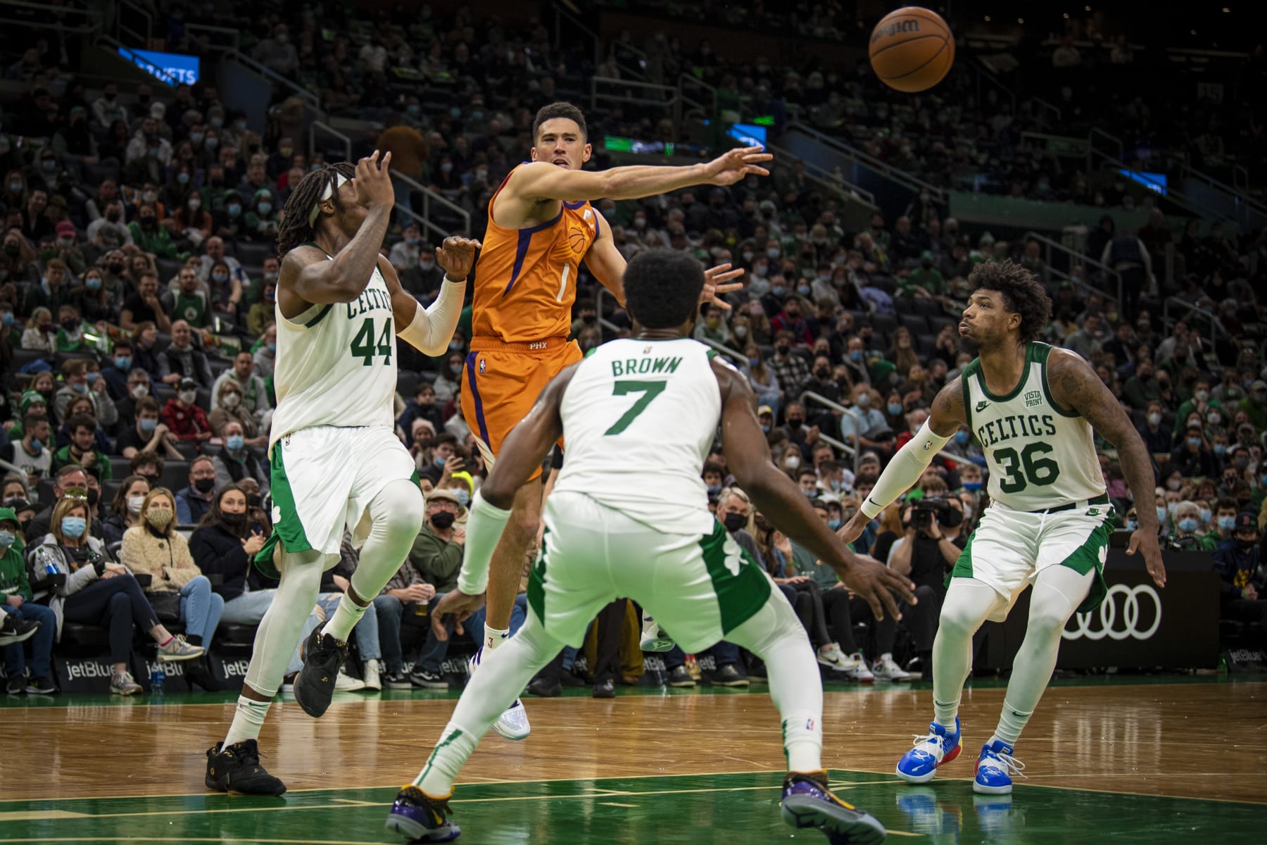 BOSTON, MASSACHUSETTS - DECEMBER 31: Devin Booker #1 of the Phoenix Suns passes the ball against the Boston Celtics during the second half of a game at TD Garden on December 31, 2021 in Boston, Massachusetts. NOTE TO USER: User expressly acknowledges and agrees that, by downloading and or using this photograph, User is consenting to the terms and conditions of the Getty Images License Agreement. (Photo by Maddie Malhotra/Getty Images)