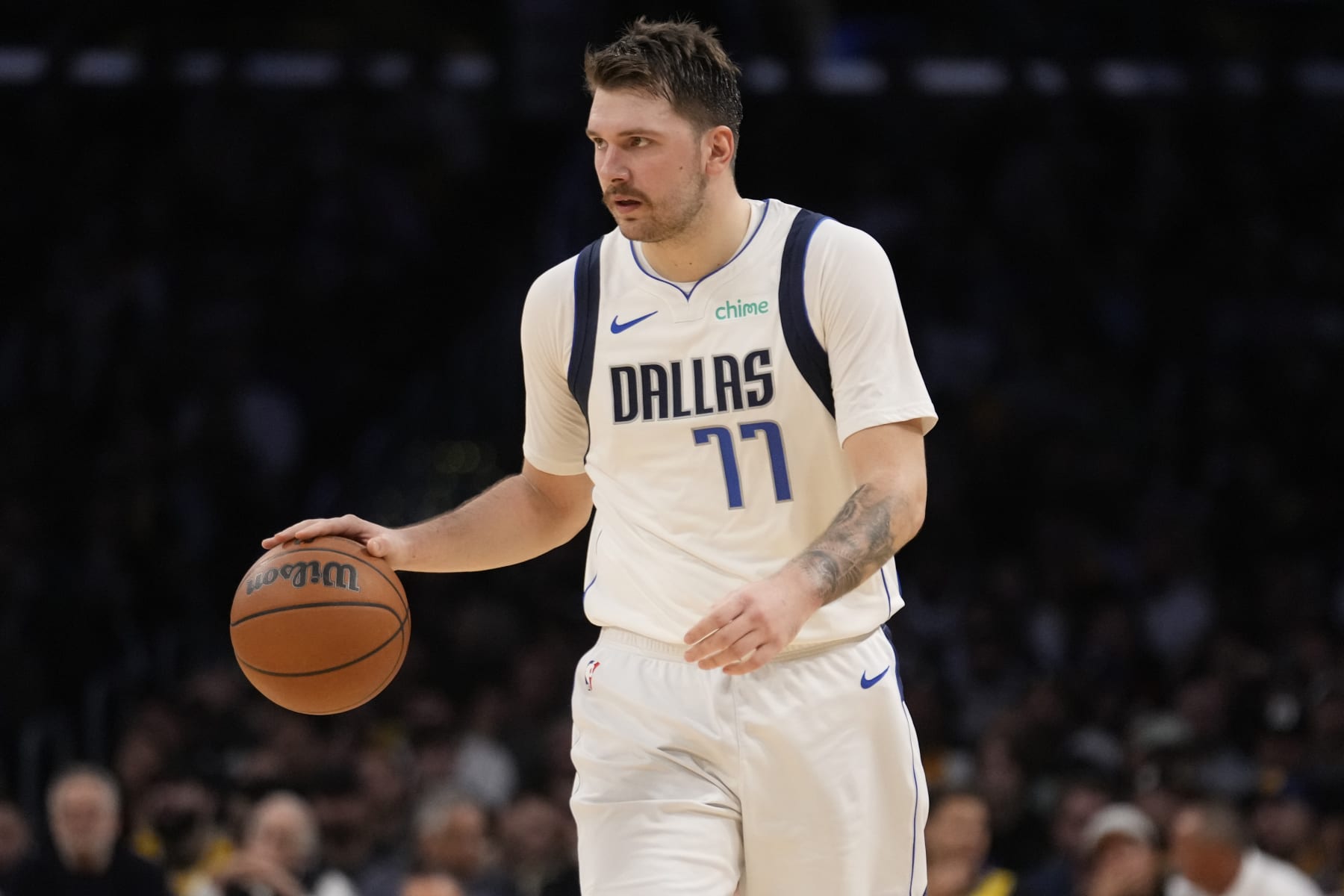 Dallas Mavericks guard Luka Doncic (77) dribbles against the Los Angeles Lakers during the second half of an NBA basketball game Wednesday, Nov. 22, 2023, in Los Angeles. (AP Photo/Marcio Jose Sanchez)