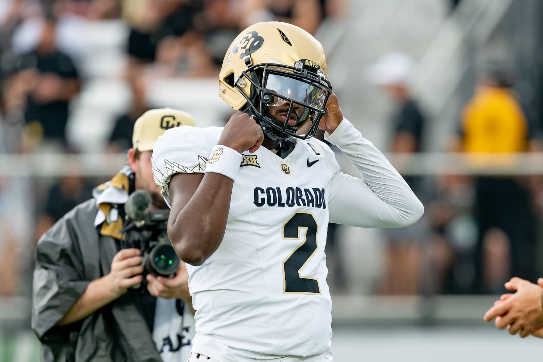 ORLANDO, FL - SEPTEMBER 28: Colorado Buffaloes quarterback Shedeur Sanders (2) fixes his helmet during warm ups before a college football game between the Colorado Buffaloes and the UCF Knights on September 28th, 2024 at FBC Mortgage Stadium in Orlando, FL. (Photo by Chris Leduc/Icon Sportswire via Getty Images)