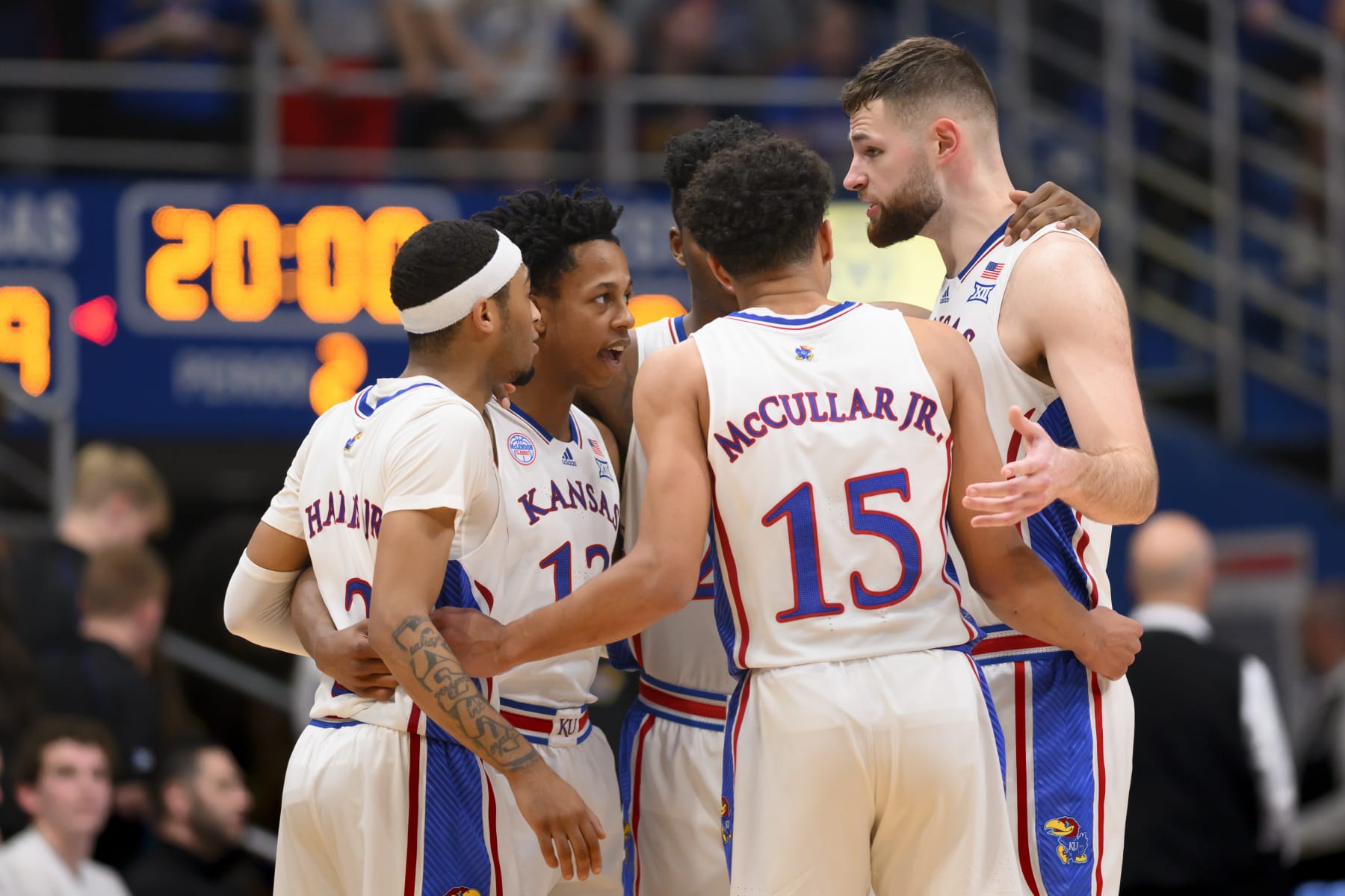 Kansas guard Dajuan Harris Jr. (3), guard Elmarko Jackson (13), guard Kevin McCullar Jr. (15) and center Hunter Dickinson, right, gather before the start of the second half of an NCAA college basketball game against North Carolina Central in Lawrence, Kan., Monday, Nov. 6, 2023. (AP Photo/Reed Hoffmann)