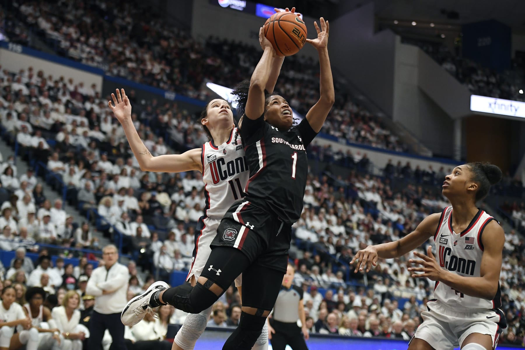UConn's Lou Lopez-Senechal (11) blocks a shot by South Carolina's Zia Cooke (1) in the first half of an NCAA college basketball game, Sunday, Feb. 5, 2023, in Hartford, Conn. (AP Photo/Jessica Hill)
