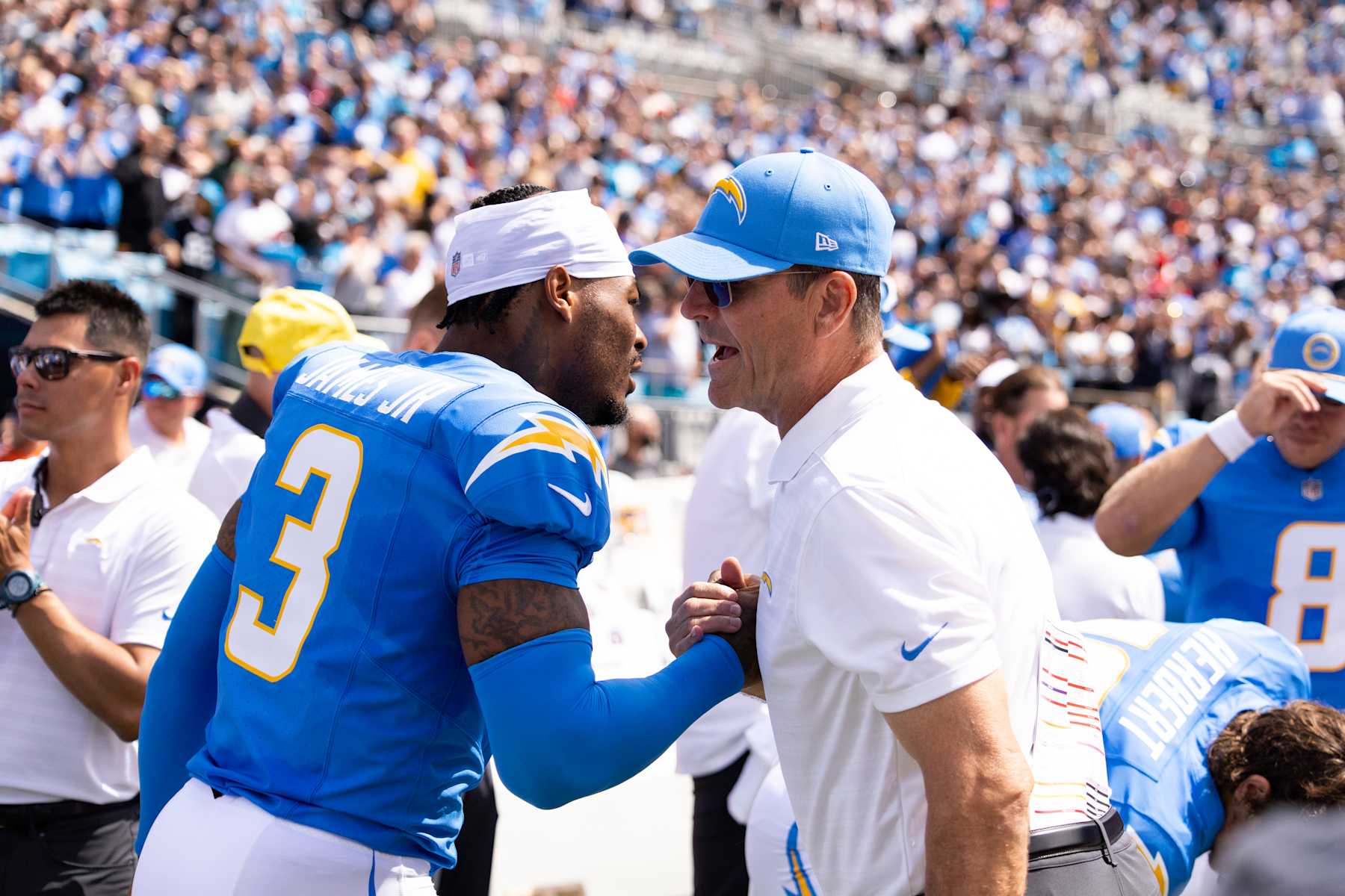 CHARLOTTE, NORTH CAROLINA - SEPTEMBER 15: Derwin James Jr. #3 of the Los Angeles Chargers greets head coach Jim Harbaugh before a game against the Carolina Panthers at Bank of America Stadium on September 15, 2024 in Charlotte, North Carolina. The Chargers defeated the Panthers 26-3. (Kara Durrette/Getty Images)