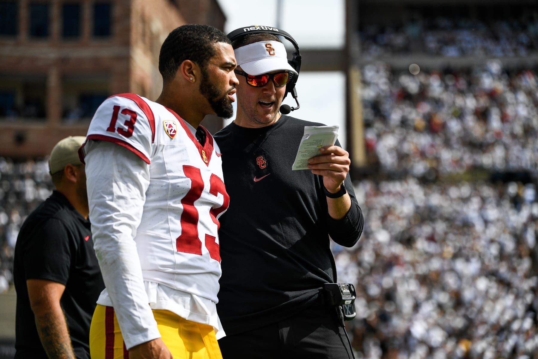BOULDER, CO - SEPTEMBER 30:  Head coach Lincoln Riley of the USC Trojans goes over the game plan with quarterback Caleb Williams #13 in the second half of a game against the Colorado Buffaloes at Folsom Field on September 30, 2023 in Boulder, Colorado. (Photo by Dustin Bradford/Getty Images)