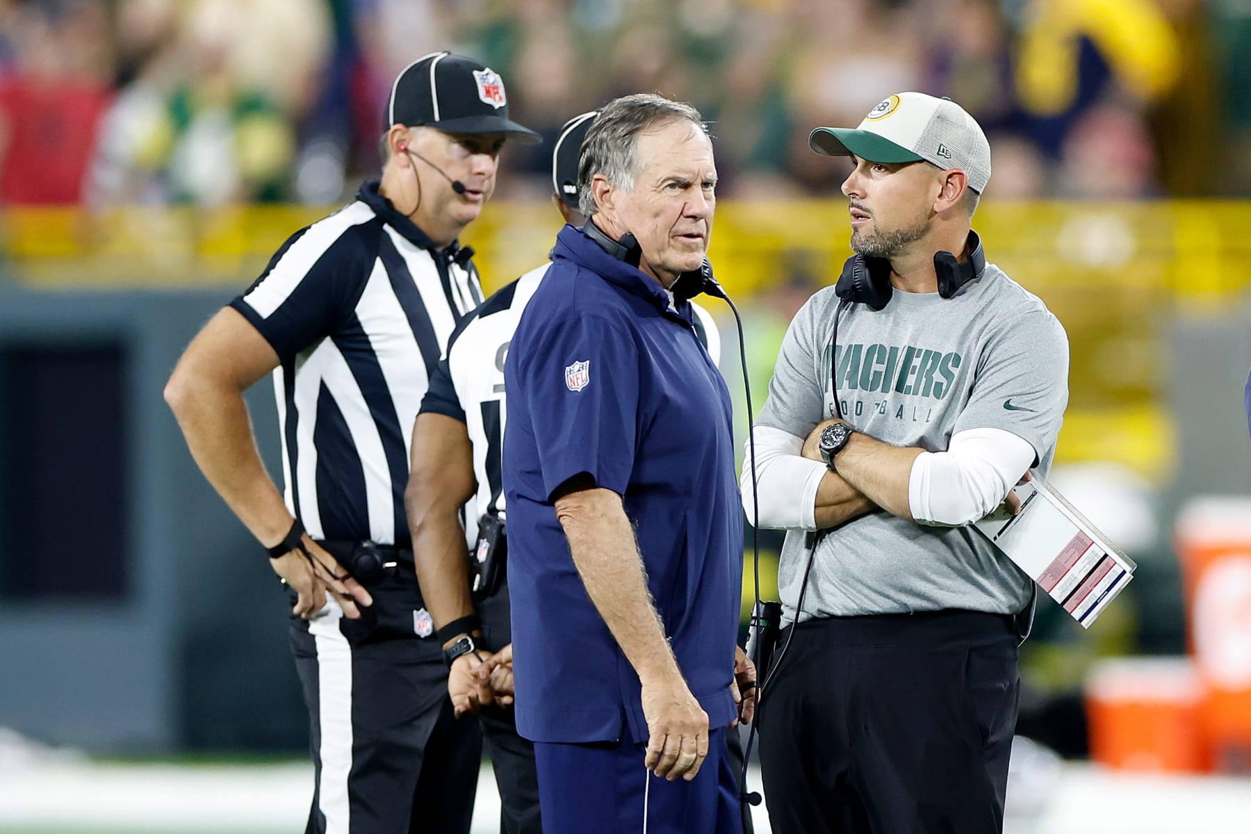 GREEN BAY, WISCONSIN - AUGUST 19: Matt LaFleur (R) head coach of the Green Bay Packers and Bill Belichick head coach of the New England Patriots agree to suspend the game after an injury to Isaiah Bolden during a preseason game at Lambeau Field on August 19, 2023 in Green Bay, Wisconsin. (Photo by John Fisher/Getty Images)