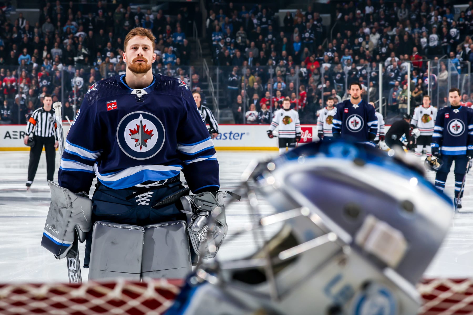 WINNIPEG, CANADA - JANUARY 11: Goaltender Laurent Brossoit #39 of the Winnipeg Jets looks on during the singing of the National anthems prior to puck drop against the Chicago Blackhawks at the Canada Life Centre on January 11, 2024 in Winnipeg, Manitoba, Canada. (Photo by Jonathan Kozub/NHLI via Getty Images)