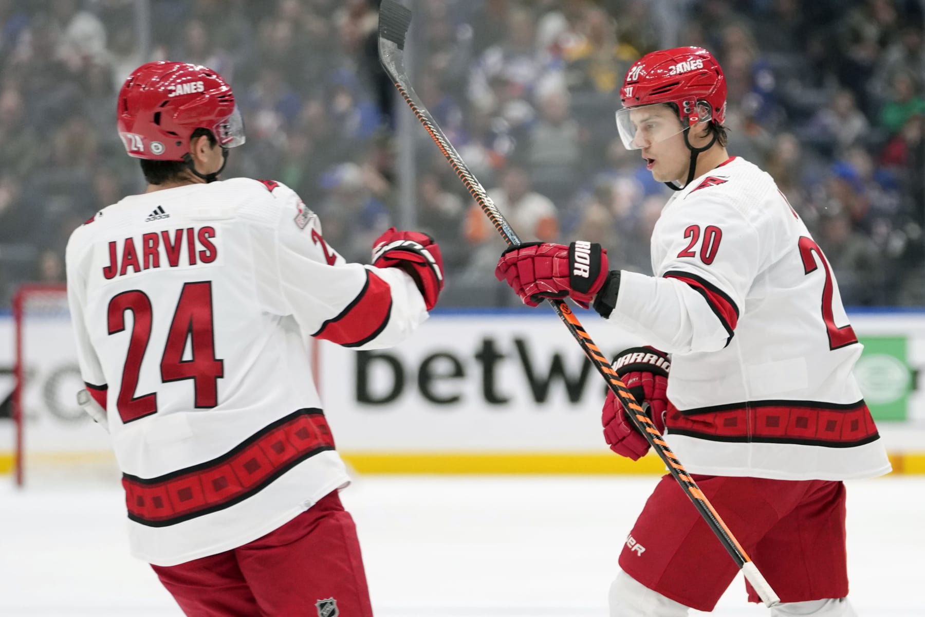 Carolina Hurricanes center Sebastian Aho (20) celebrates with center Seth Jarvis (24) after scoring against the New York Islanders during the third period of an NHL hockey game, Saturday, Jan. 21, 2023, in Elmont, N.Y. (AP Photo/Mary Altaffer)