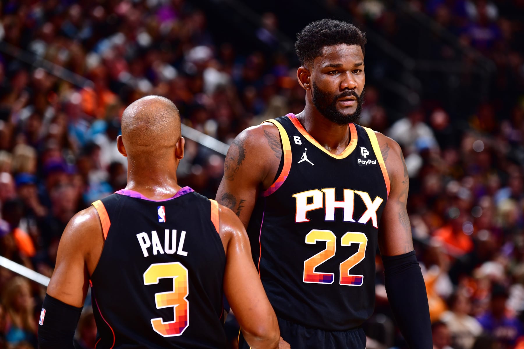 PHOENIX, AZ - APRIL 16: Chris Paul #3 and Deandre Ayton #22 of the Phoenix Suns interact during the game against the LA Clippers During round one game one of the 2023 NBA Playoffs on April 16, 2023 at Footprint Center in Phoenix, Arizona. NOTE TO USER: User expressly acknowledges and agrees that, by downloading and or using this photograph, user is consenting to the terms and conditions of the Getty Images License Agreement. Mandatory Copyright Notice: Copyright 2023 NBAE (Photo by Barry Gossage/NBAE via Getty Images)