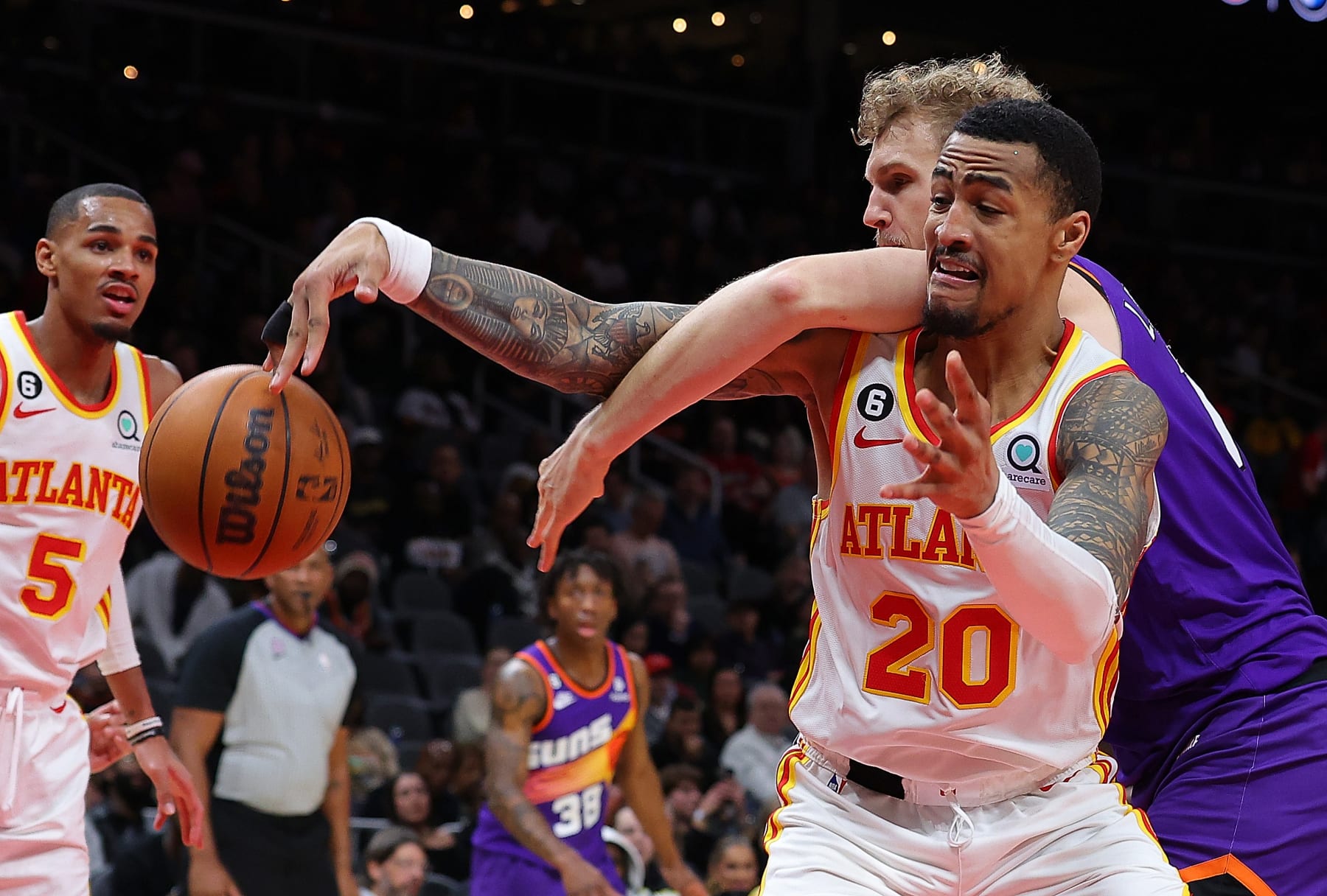 ATLANTA, GEORGIA - FEBRUARY 09:  John Collins #20 of the Atlanta Hawks battles for a rebound against Jock Landale #11 of the Phoenix Suns during the fourth quarter at State Farm Arena on February 09, 2023 in Atlanta, Georgia.  NOTE TO USER: User expressly acknowledges and agrees that, by downloading and or using this photograph, User is consenting to the terms and conditions of the Getty Images License Agreement. (Photo by Kevin C. Cox/Getty Images)