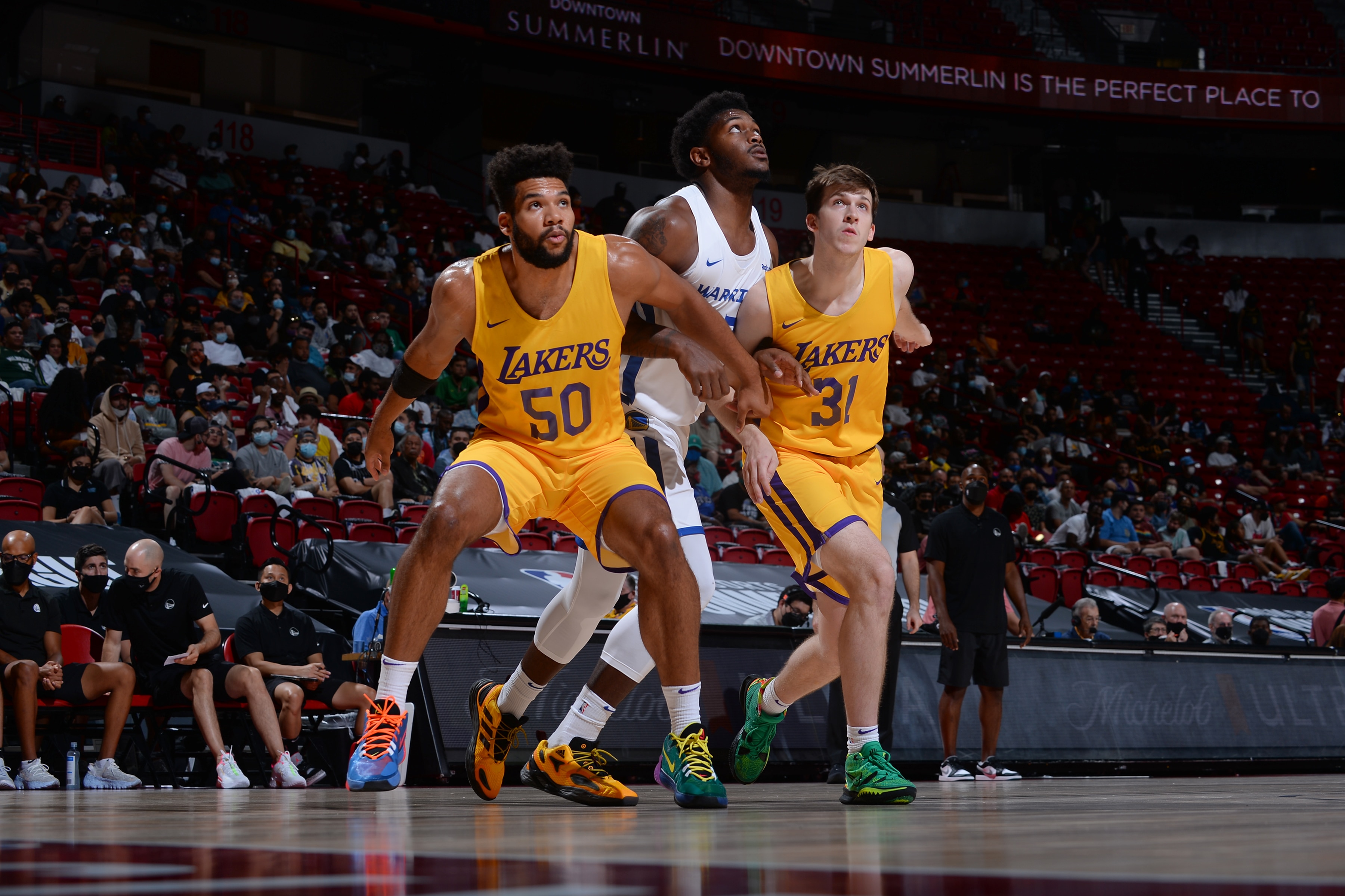 LAS VEGAS, NV - AUGUST 17:  Yoeli Childs #50 and Austin Reaves #31 of the Los Angeles Lakers look on during the game against the Golden State Warriors during the 2021 Las Vegas Summer League on August 17, 2021 at the Thomas & Mack Center in Las Vegas, Nevada. NOTE TO USER: User expressly acknowledges and agrees that, by downloading and or using this Photograph, User is consenting to the terms and conditions of the Getty Images License Agreement. Mandatory Copyright Notice: Copyright 2021 NBAE (Photo by Bart Young/NBAE via Getty Images)