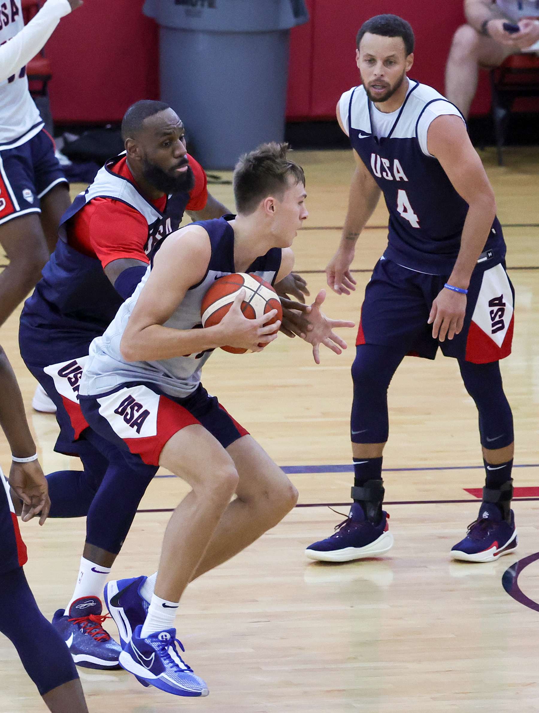LAS VEGAS, NEVADA - JULY 08: Cooper Flagg #31 of the 2024 USA Basketball Men's Select Team drives to the basket against LeBron James #6 and Stephen Curry #4 of the 2024 USA Basketball Men's National Team during a practice session scrimmage at the team's training camp at the Mendenhall Center at UNLV on July 08, 2024 in Las Vegas, Nevada. (Photo by Ethan Miller/Getty Images)