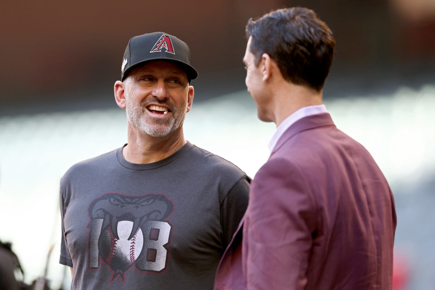 PHOENIX, ARIZONA - OCTOBER 11: Manager Torey Lovullo (L) and general manager Mike Hazen of the Arizona Diamondbacks meet before during Game Three of the Division Series against the Los Angeles Dodgers at Chase Field on October 11, 2023 in Phoenix, Arizona. (Photo by Elsa/Getty Images)