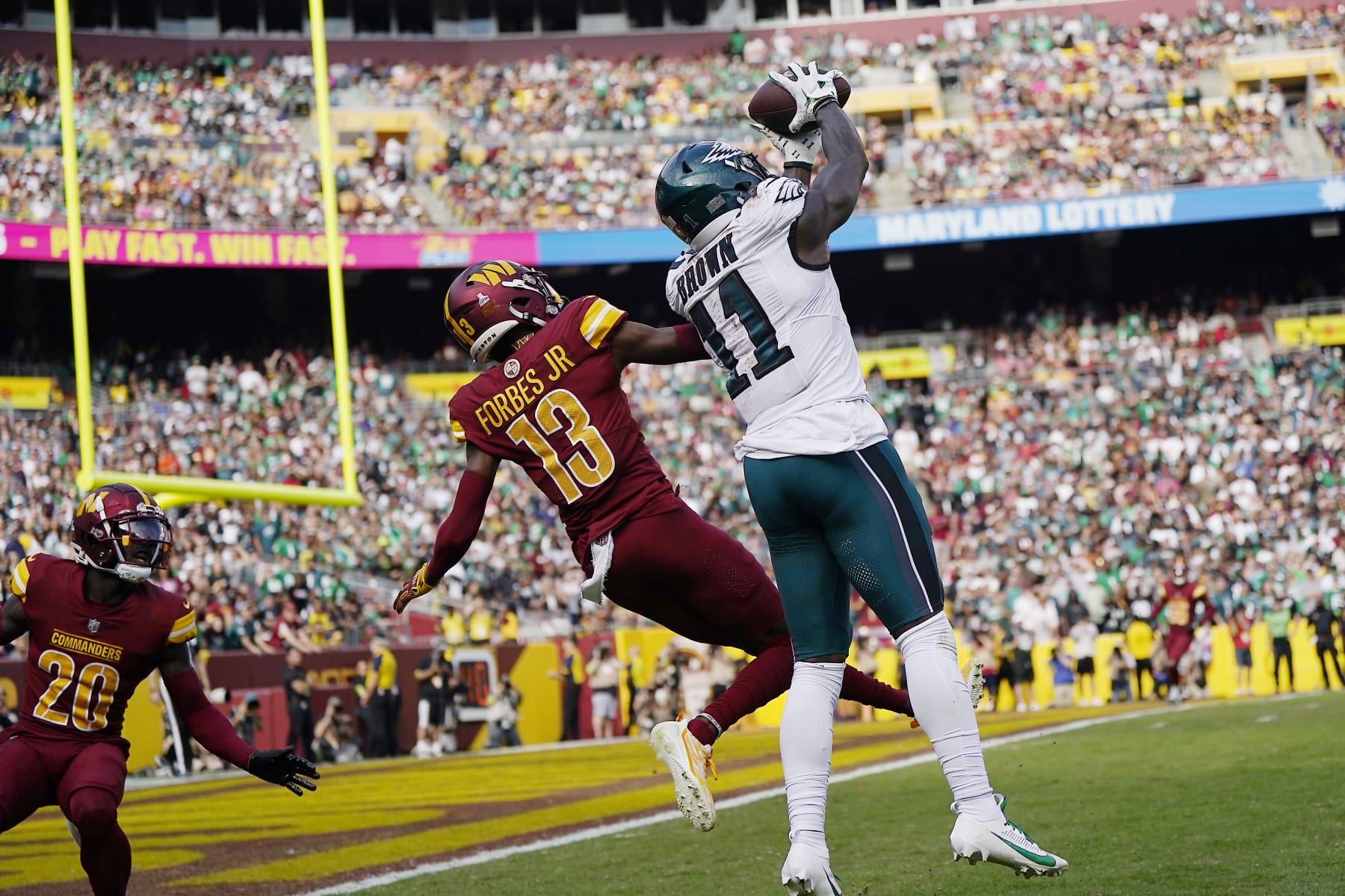 LANDOVER, MARYLAND - OCTOBER 29: A.J. Brown #11 of the Philadelphia Eagles catches a pass for a touchdown over Emmanuel Forbes #13 of the Washington Commanders in the third quarter of a game at FedExField on October 29, 2023 in Landover, Maryland. (Photo by Jess Rapfogel/Getty Images)