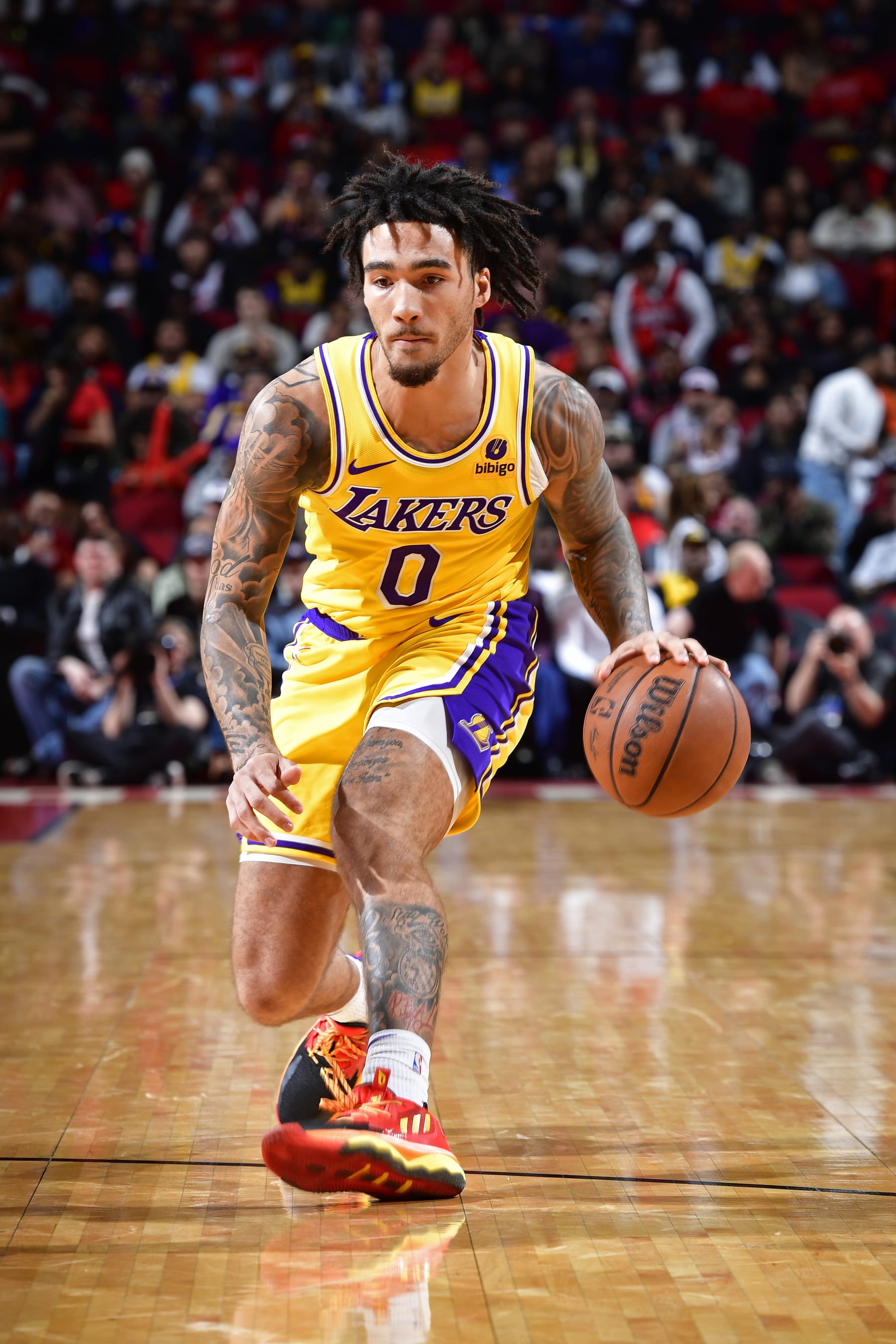 HOUSTON, TX - JANUARY 29:  Jalen Hood-Schifino #0 of the Los Angeles Lakers  dribbles the ball during the game against the Houston Rockets on January 29, 2024 at the Toyota Center in Houston, Texas. NOTE TO USER: User expressly acknowledges and agrees that, by downloading and or using this photograph, User is consenting to the terms and conditions of the Getty Images License Agreement. Mandatory Copyright Notice: Copyright 2024 NBAE (Photo by Logan Riely/NBAE via Getty Images)
