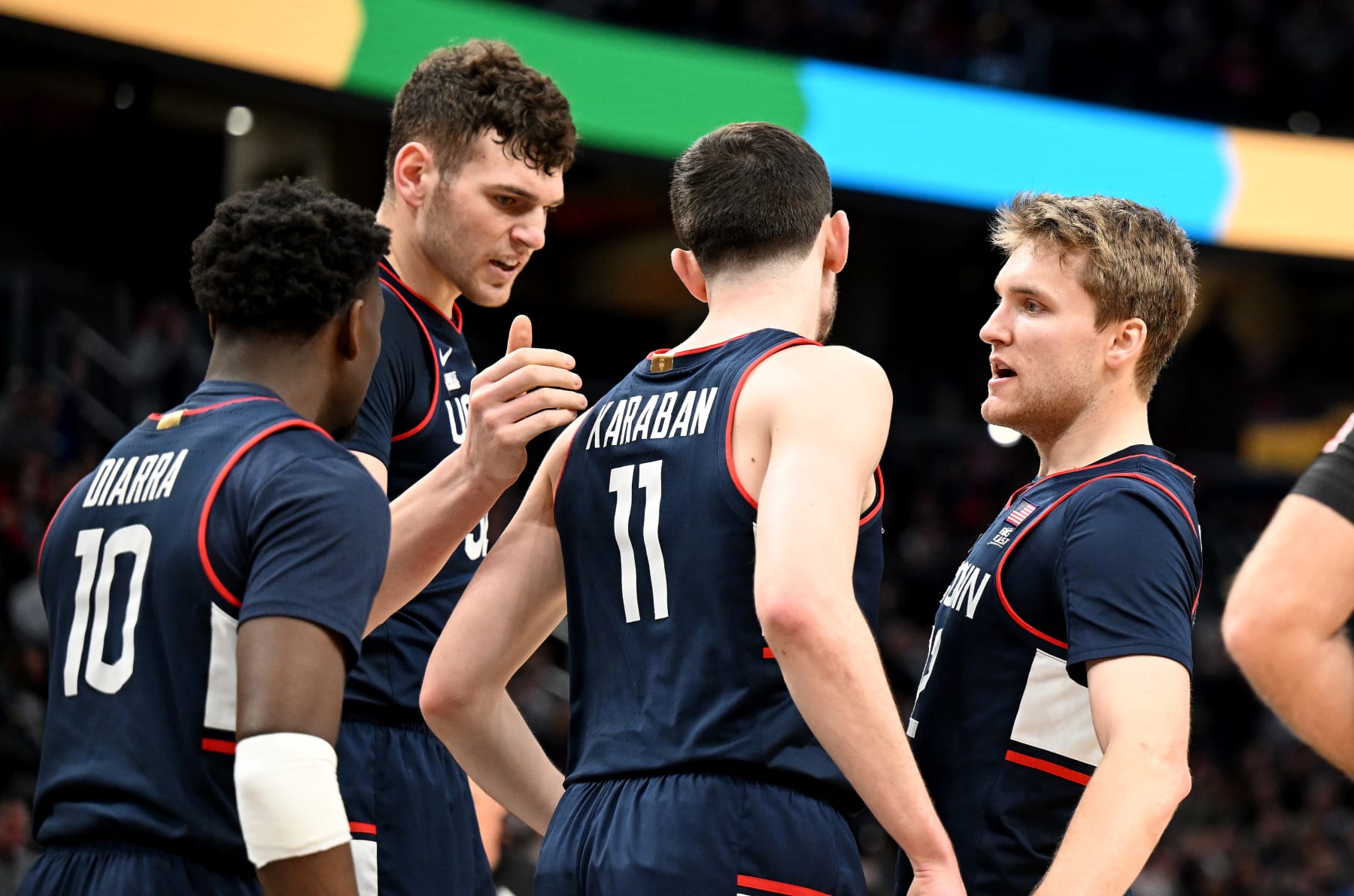 WASHINGTON, DC - FEBRUARY 10: Cam Spencer #12, Alex Karaban #11, Donovan Clingan #32 and Hassan Diarra #10 of the Connecticut Huskies celebrate in the first half against the Georgetown Hoyas at Capital One Arena on February 10, 2024 in Washington, DC. (Photo by Greg Fiume/Getty Images)