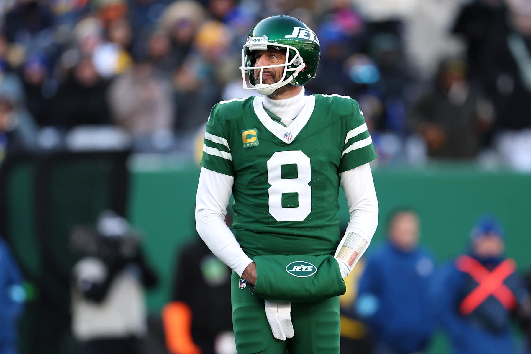 EAST RUTHERFORD, NEW JERSEY - DECEMBER 22: Aaron Rodgers #8 of the New York Jets looks on during the first half against the Los Angeles Rams at MetLife Stadium on December 22, 2024 in East Rutherford, New Jersey. (Photo by Emilee Chinn/Getty Images)