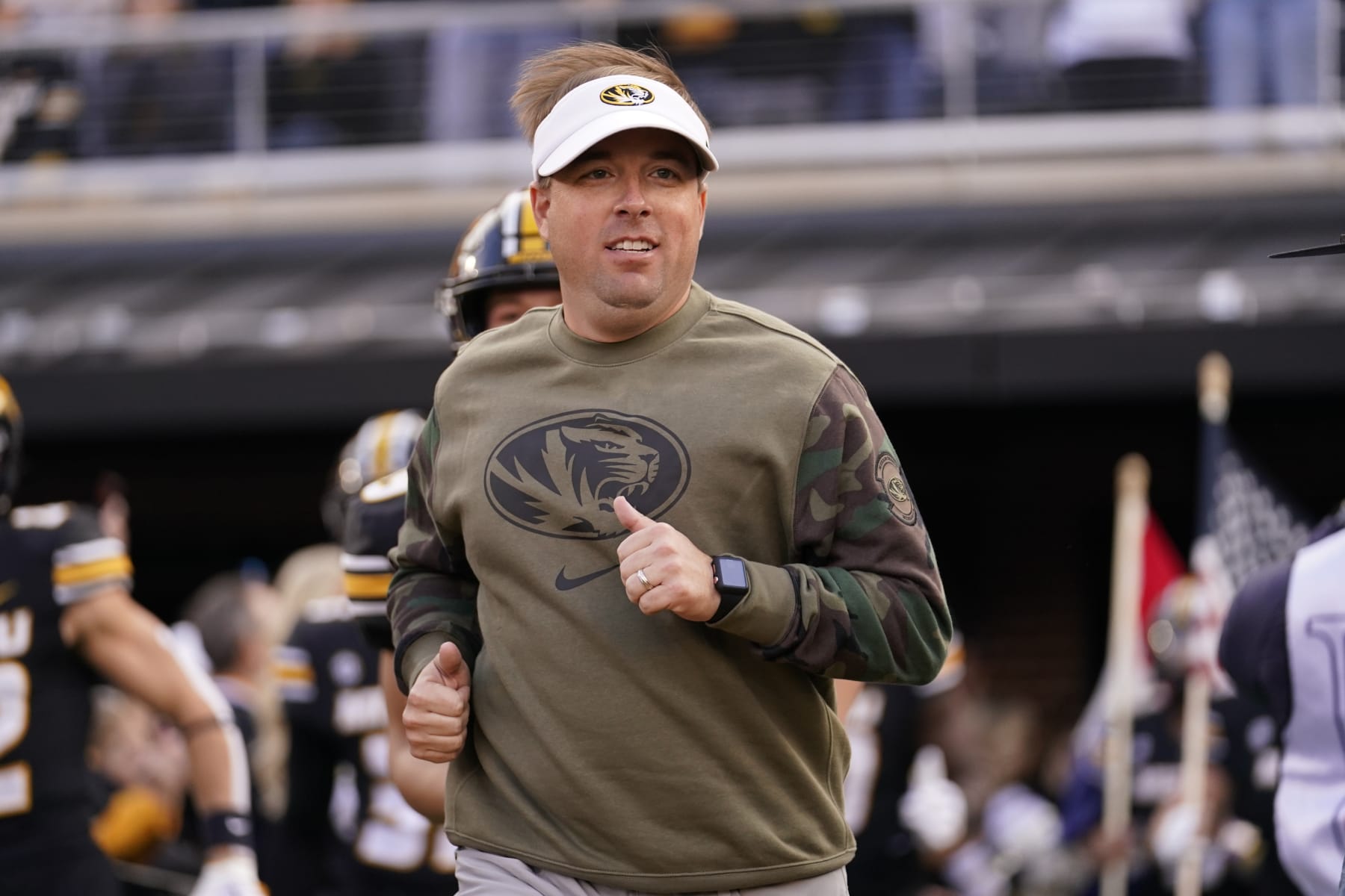 Missouri head coach Eliah Drinkwitz jogs out to the field at the start of an NCAA college football game against Tennessee Saturday, Nov. 11, 2023, in Columbia, Mo. (AP Photo/Jeff Roberson)