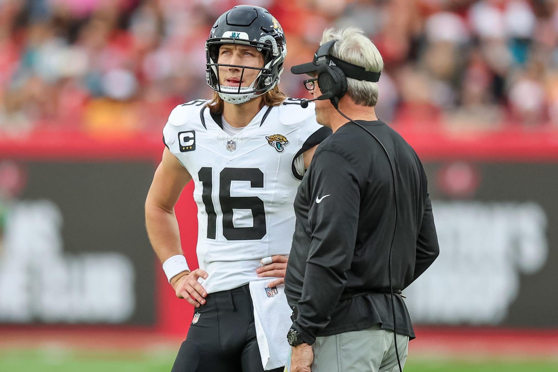 TAMPA, FLORIDA - DECEMBER 24: Trevor Lawrence #16 of the Jacksonville Jaguars talks with head coach Doug Pederson during the first half of the game against the Tampa Bay Buccaneers at Raymond James Stadium on December 24, 2023 in Tampa, Florida. (Photo by Mike Carlson/Getty Images)