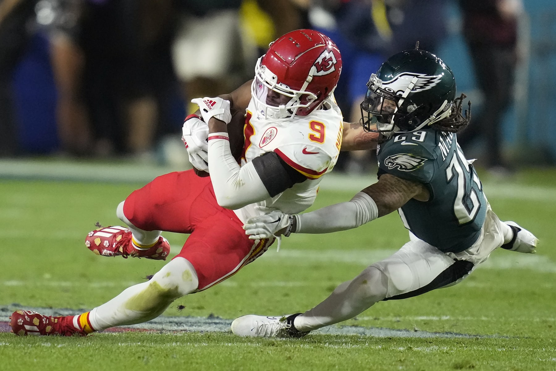 Kansas City Chiefs wide receiver JuJu Smith-Schuster (9) falls to the turf against Philadelphia Eagles cornerback Avonte Maddox (29) during the second half of the NFL Super Bowl 57 football game, Sunday, Feb. 12, 2023, in Glendale, Ariz. (AP Photo/Ashley Landis)