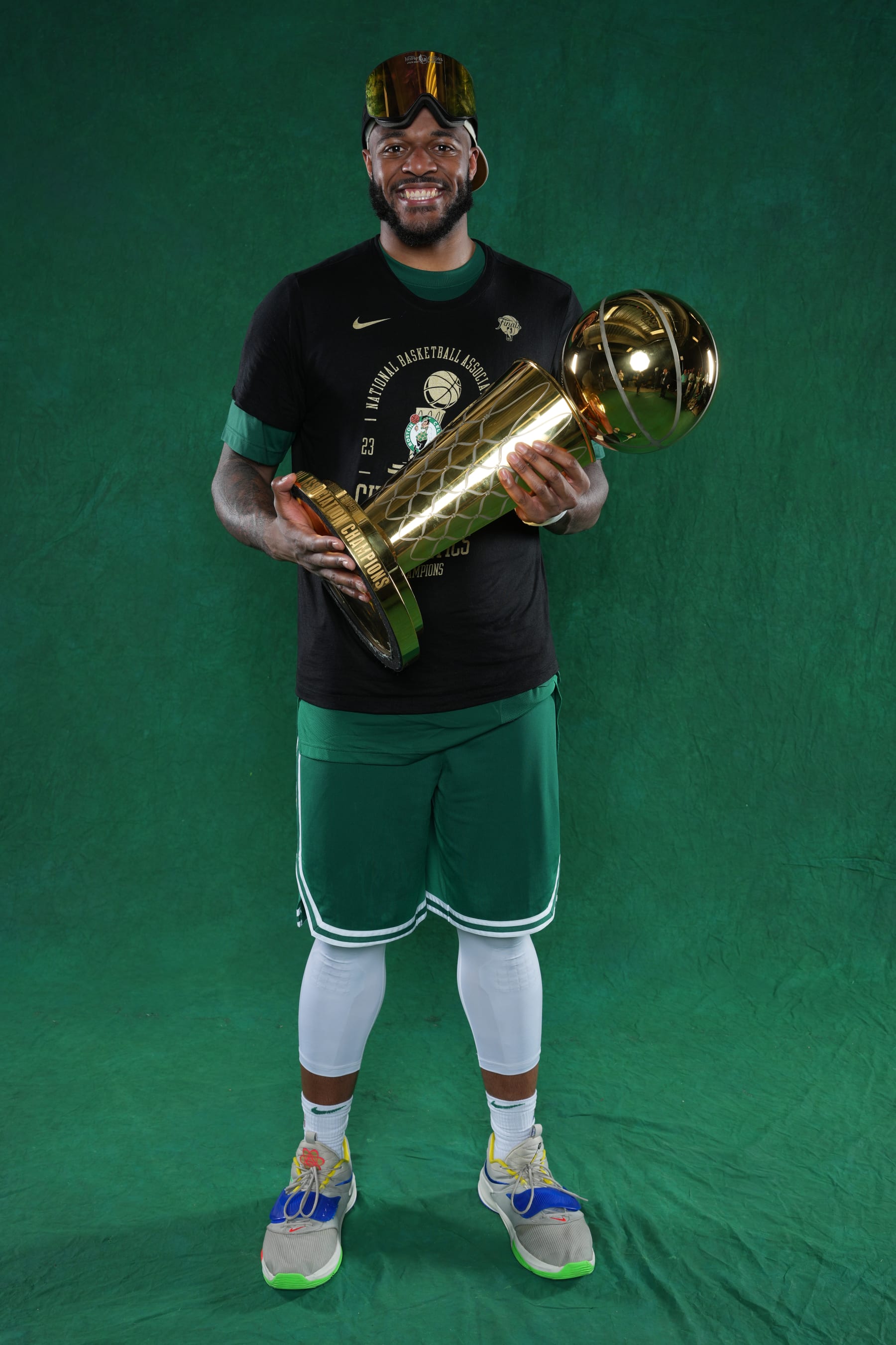 BOSTON, MA - JUNE 17: Xavier Tillman #26 of the Boston Celtics poses for a portrait with the Larry O'Brian Trophy after winning Game 5 of the 2024 NBA Finals on June 17, 2024 at the TD Garden in Boston, Massachusetts. NOTE TO USER: User expressly acknowledges and agrees that, by downloading and or using this photograph, User is consenting to the terms and conditions of the Getty Images License Agreement. Mandatory Copyright Notice: Copyright 2024 NBAE  (Photo by Jesse D. Garrabrant/NBAE via Getty Images)