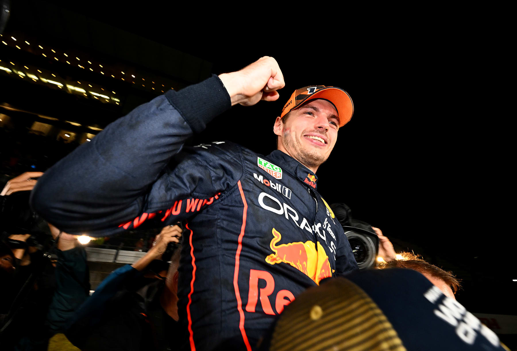 SUZUKA, JAPAN - OCTOBER 09: Race winner and 2022 F1 World Drivers Champion Max Verstappen of Netherlands and Oracle Red Bull Racing celebrates with his team after the F1 Grand Prix of Japan at Suzuka International Racing Course on October 09, 2022 in Suzuka, Japan. (Photo by Clive Mason/Getty Images)