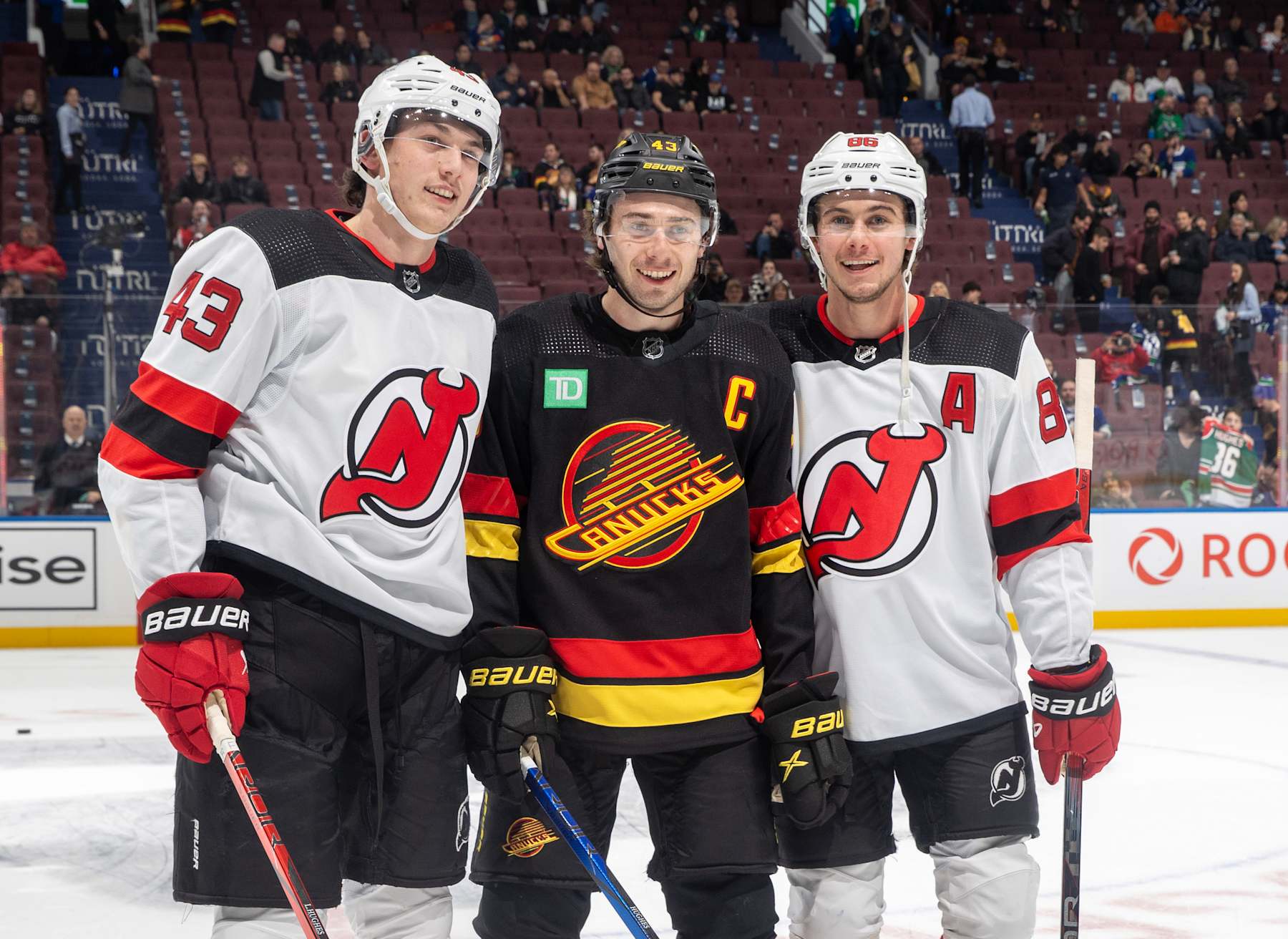 VANCOUVER, CANADA - DECEMBER 05: Quinn Hughes #43 of the Vancouver Canucks and Jack Hughes #86 and Luke Hughes #43 of the New Jersey Devils pose for a photo before their NHL game at Rogers Arena on December 5, 2023 in Vancouver, British Columbia, Canada.  (Photo by Jeff Vinnick/NHLI via Getty Images)