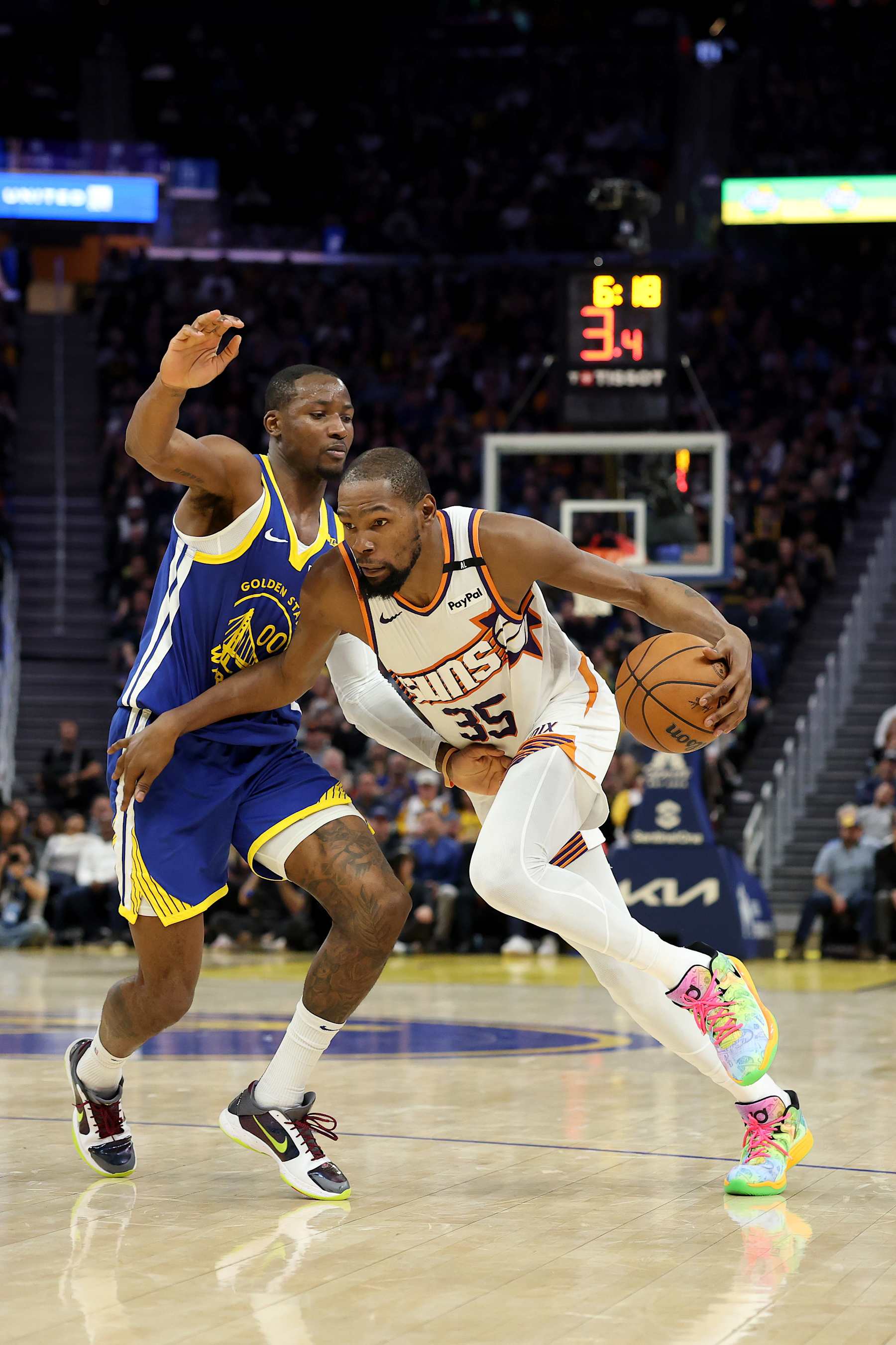 SAN FRANCISCO, CALIFORNIA - DECEMBER 28: Kevin Durant #35 of the Phoenix Suns is guarded by Jonathan Kuminga #00 of the Golden State Warriors at Chase Center on December 28, 2024 in San Francisco, California. NOTE TO USER: User expressly acknowledges and agrees that, by downloading and/or using this photograph, user is consenting to the terms and conditions of the Getty Images License Agreement.   (Photo by Ezra Shaw/Getty Images)