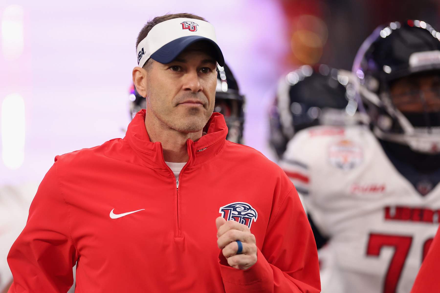 GLENDALE, ARIZONA - JANUARY 01: Head coach Jamey Chadwell of the Liberty Flames leads teammates onto the field before the Fiesta Bowl against the Oregon Ducks at State Farm Stadium on January 01, 2024 in Glendale, Arizona. (Photo by Christian Petersen/Getty Images)