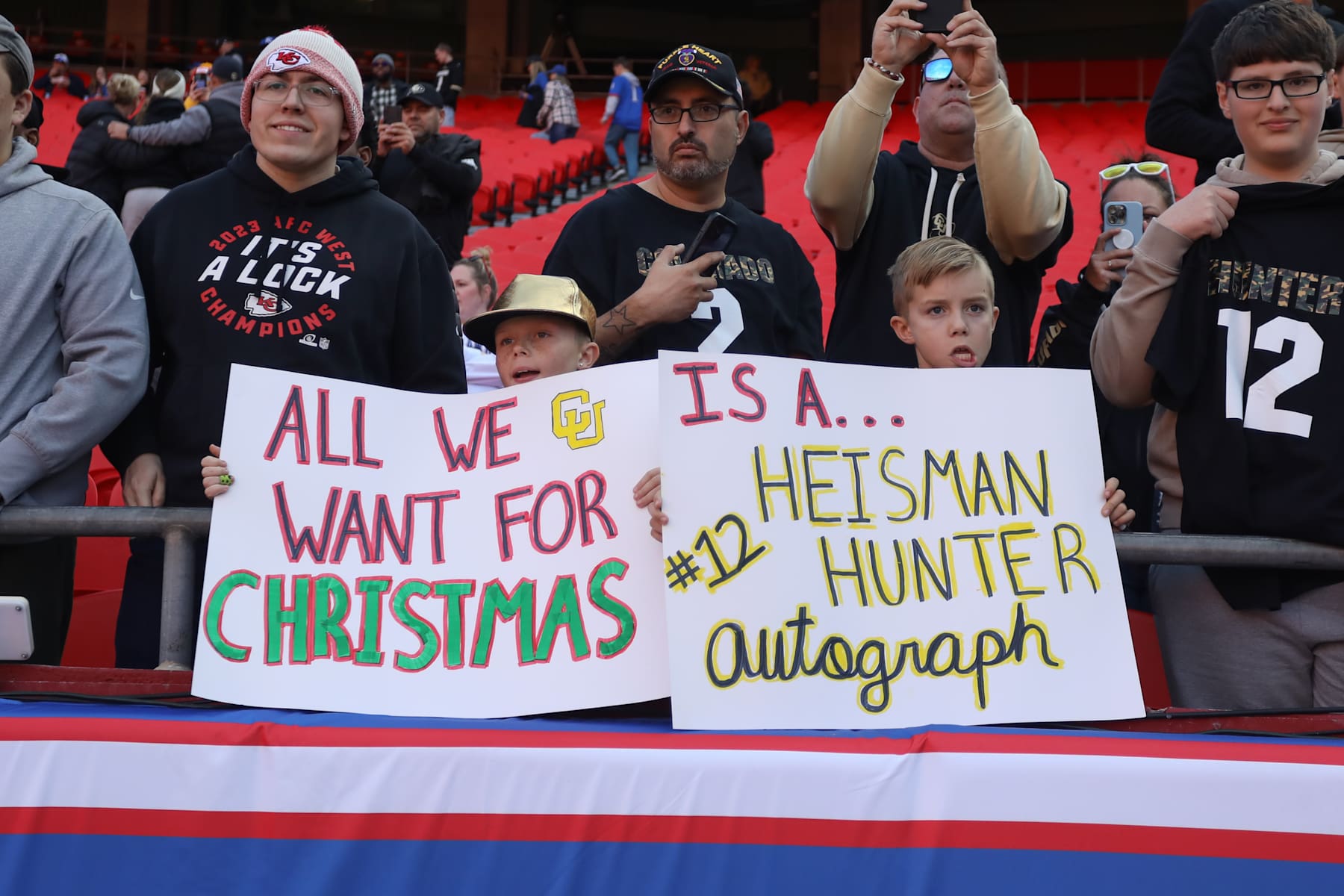 KANSAS CITY, MO - NOVEMBER 23: Colorado Buffaloes fans hold signs supporting Travis Hunter (12) for the Heisman Trophy before a Big 12 game between the Colorado Buffaloes and Kansas Jayhawks on November 23, 2024 at GEHA Field at Arrowhead Stadium in Kansas City, MO. (Photo by Scott Winters/Icon Sportswire via Getty Images)