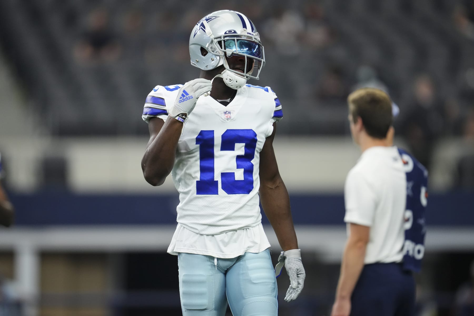ARLINGTON, TEXAS - AUGUST 29: Michael Gallup #13 of the Dallas Cowboys straps his helmet prior to an NFL game against the Jacksonville Jaguars at AT&T Stadium on August 29, 2021 in Arlington, Texas. (Photo by Cooper Neill/Getty Images)