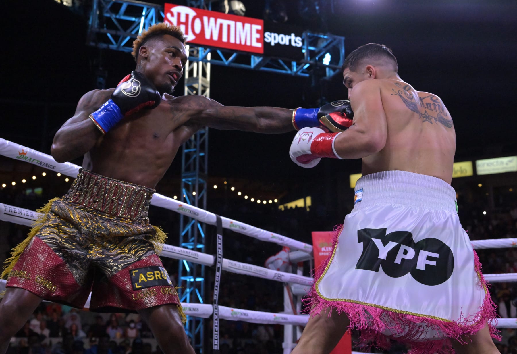 CARSON, CA - MAY 14: Jermell Charlo (gold/red shorts) exchanges punches in the ring with Brian Castano (white/pink shorts) during their super middleweight title fight at Dignity Health Sports Park on May 14, 2022 in Carson, California. Charlo won by knockout in the 10th round. (Photo by Jayne Kamin-Oncea/Getty Images)