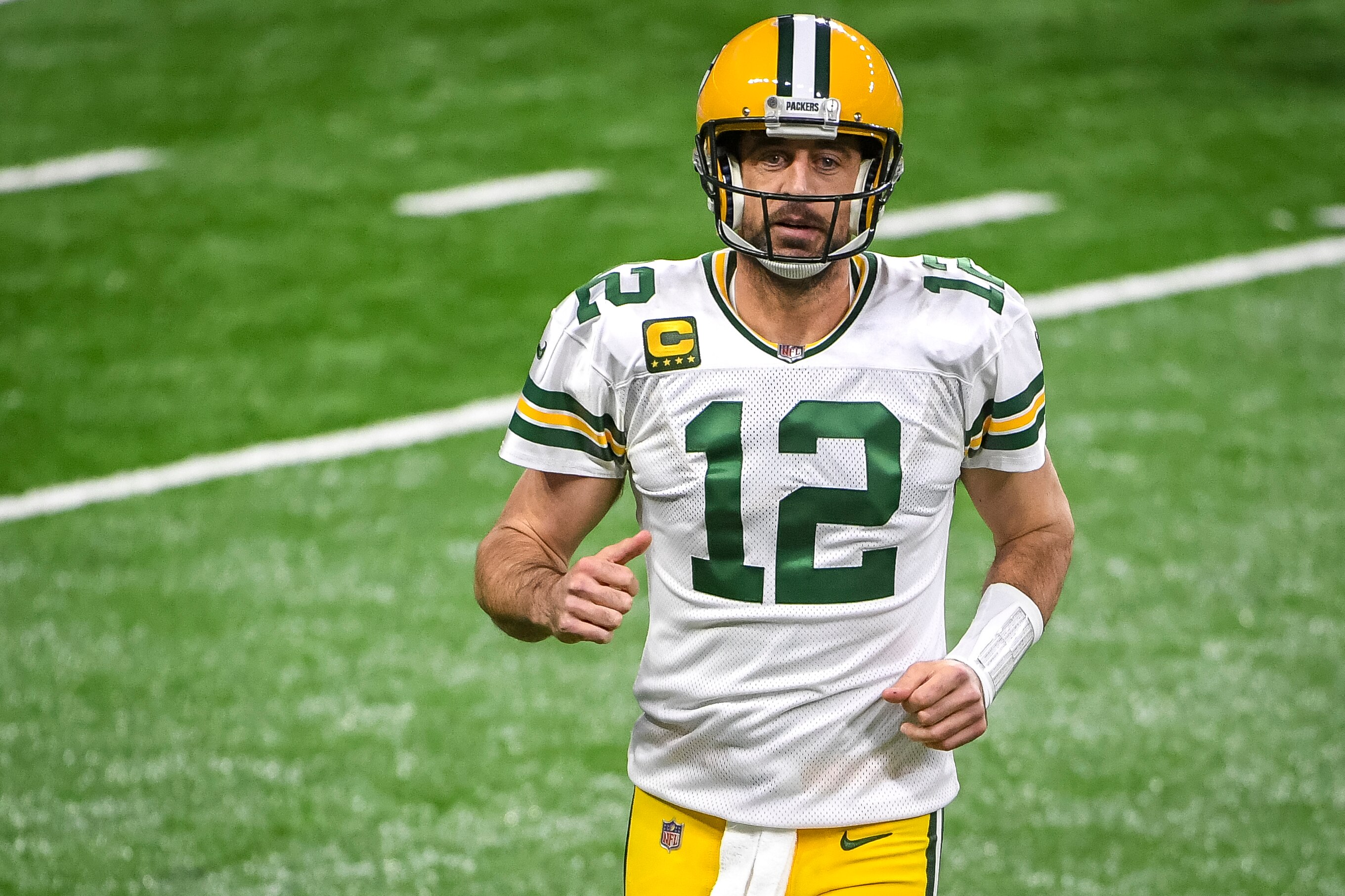 DETROIT, MICHIGAN - DECEMBER 13: Aaron Rodgers #12 of the Green Bay Packers runs off the field during the first half against the Detroit Lions at Ford Field on December 13, 2020 in Detroit, Michigan. (Photo by Nic Antaya/Getty Images)