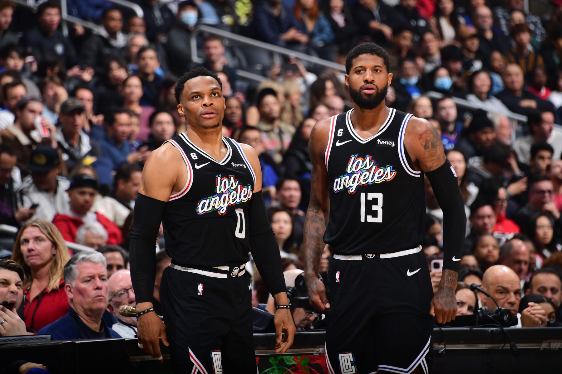 LOS ANGELES, CA - FEBRUARY 24: Russell Westbrook #0 and Paul George #13 of the LA Clippers look on during the game against the Sacramento Kings on February 24, 2023 at Crypto.Com Arena in Los Angeles, California. NOTE TO USER: User expressly acknowledges and agrees that, by downloading and/or using this Photograph, user is consenting to the terms and conditions of the Getty Images License Agreement. Mandatory Copyright Notice: Copyright 2023 NBAE (Photo by Adam Pantozzi/NBAE via Getty Images)