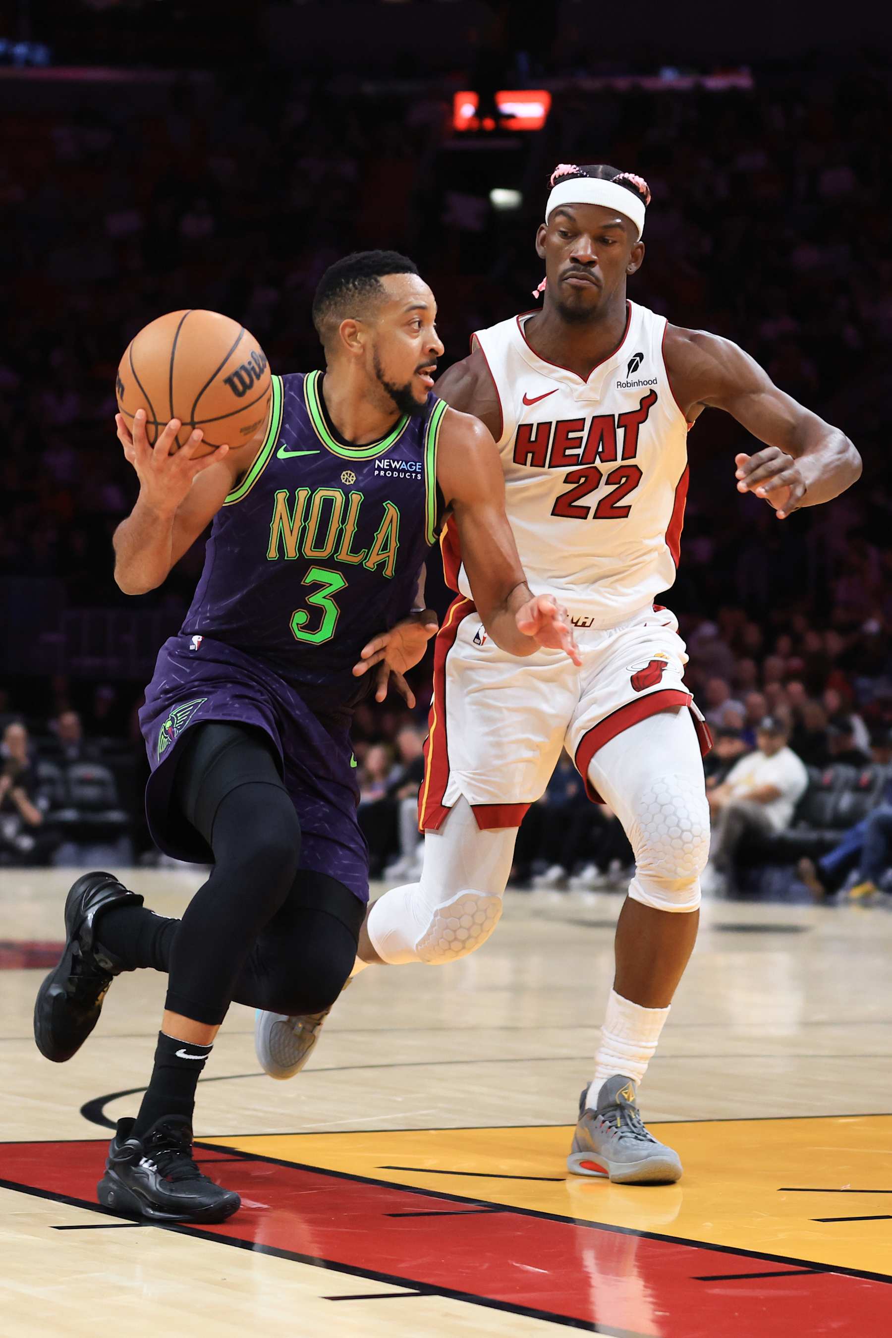 MIAMI, FLORIDA - JANUARY 01: CJ McCollum #3 of the New Orleans Pelicans drives against Jimmy Butler #22 of the Miami Heat d\3q\ at Kaseya Center on January 01, 2025 in Miami, Florida. NOTE TO USER: User expressly acknowledges and agrees that, by downloading and or using this photograph, User is consenting to the terms and conditions of the Getty Images License Agreement. (Photo by Megan Briggs/Getty Images)