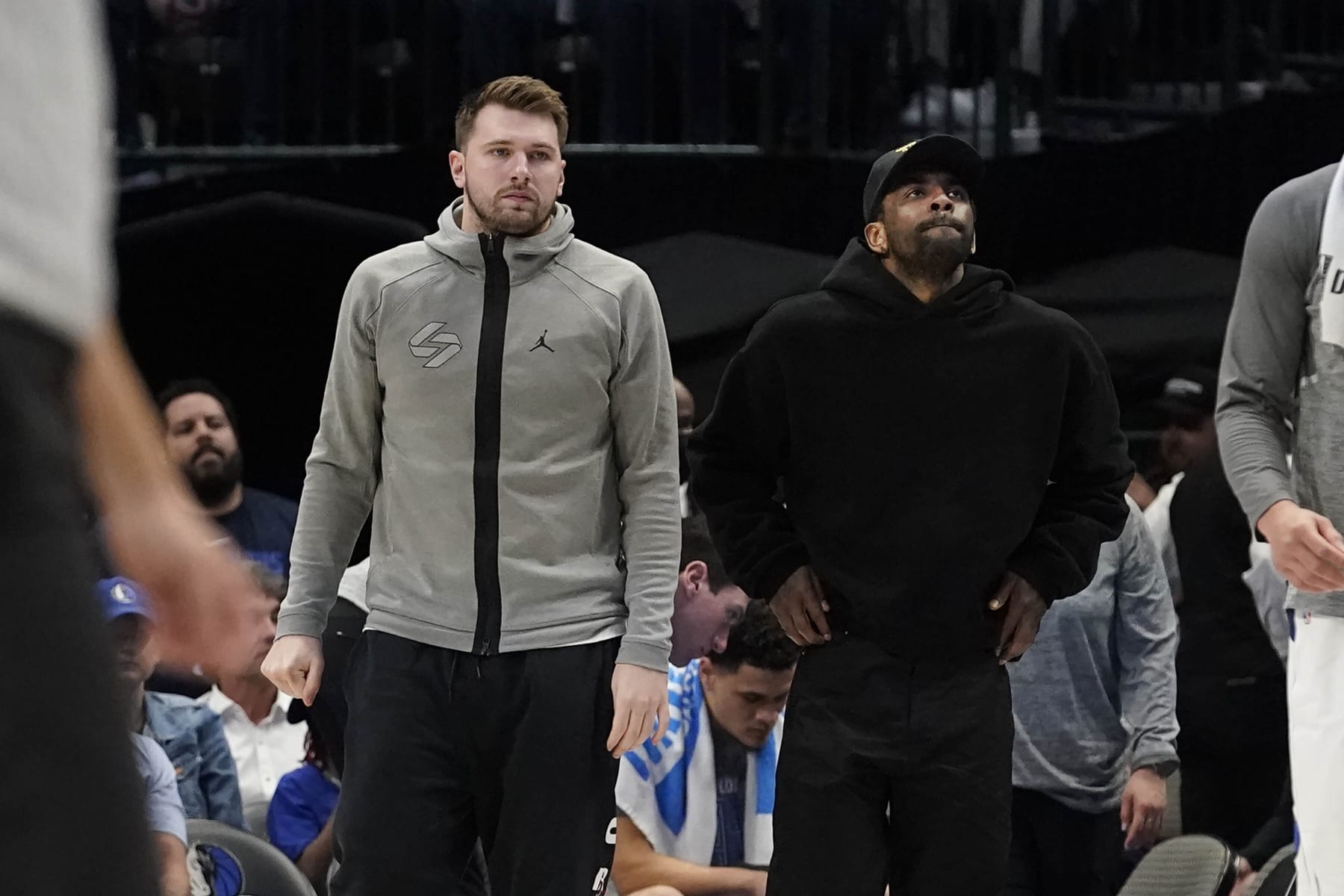 Dallas Mavericks' Luka Doncic, left, and Kyrie Irving look on from the sideline during the second half of an NBA basketball game against the Memphis Grizzlies in Dallas, Monday, March 13, 2023. (AP Photo/LM Otero)