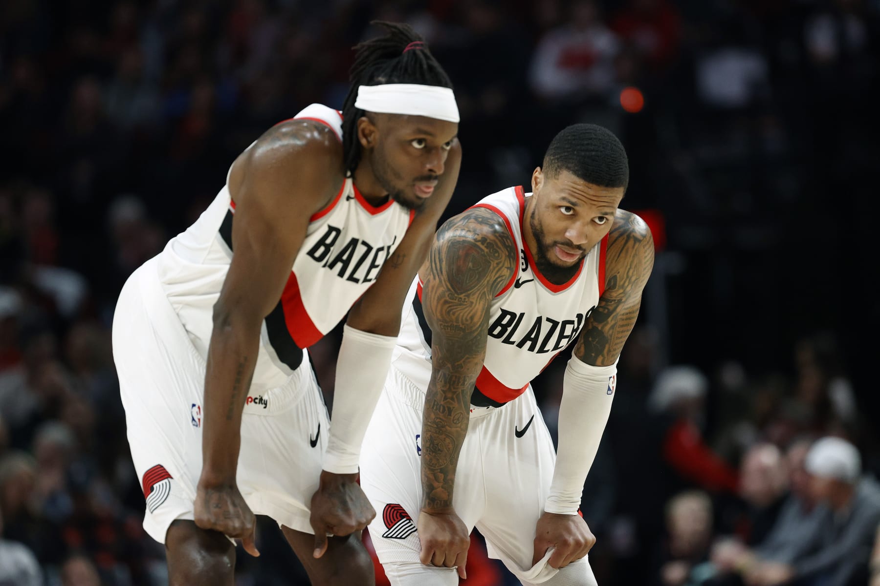 PORTLAND, OREGON - JANUARY 14: Jerami Grant #9 and Damian Lillard #0 of the Portland Trail Blazers look on during the first half at Moda Center on January 14, 2023 in Portland, Oregon. NOTE TO USER: User expressly acknowledges and agrees that, by downloading and or using this photograph, user is consenting to the terms and conditions of the Getty Images License Agreement. (Photo by Steph Chambers/Getty Images)