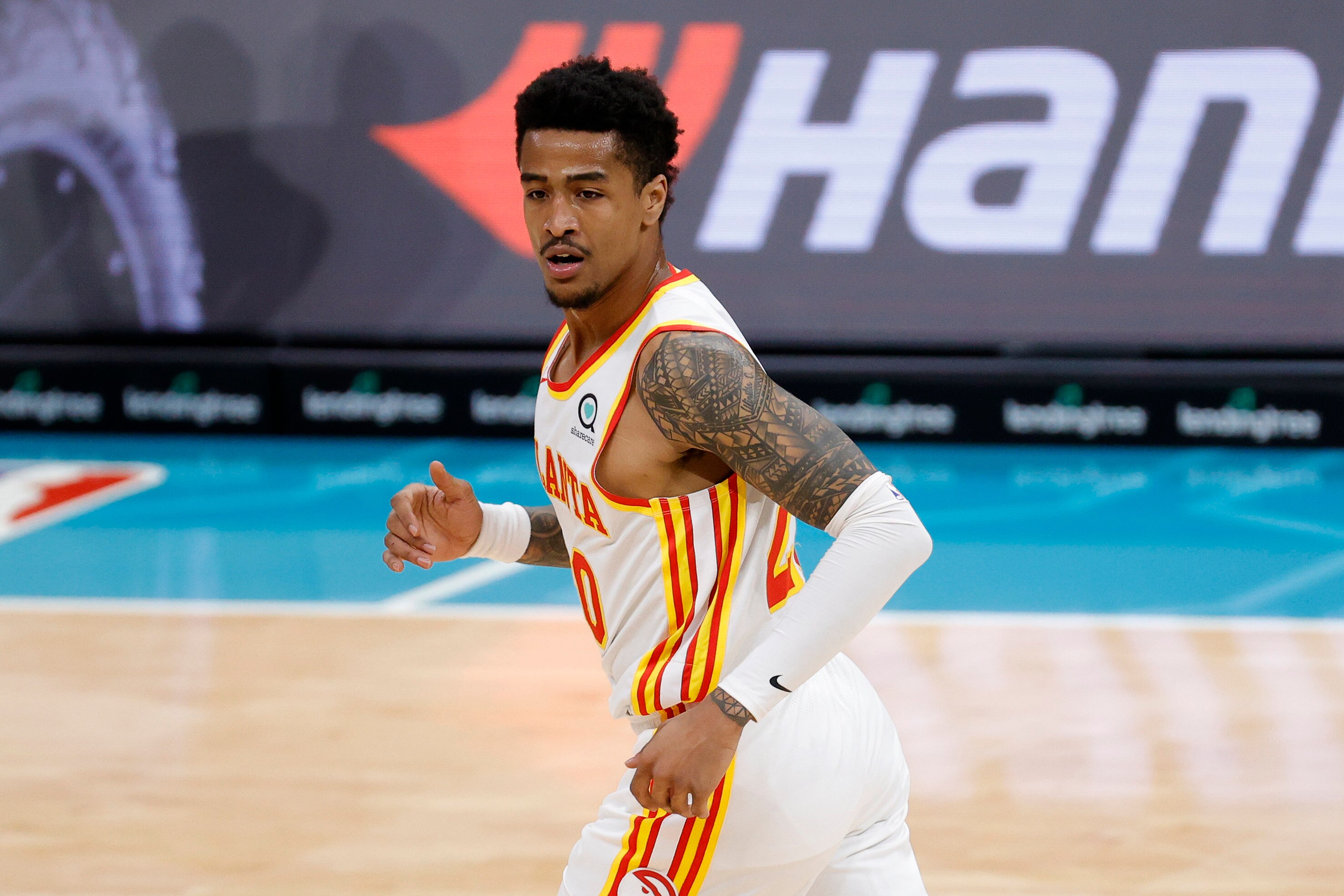 CHARLOTTE, NORTH CAROLINA - JANUARY 09: John Collins #20 of the Atlanta Hawks reacts following a three point basket during the first quarter of their game against the Charlotte Hornets at Spectrum Center on January 09, 2021 in Charlotte, North Carolina. NOTE TO USER: User expressly acknowledges and agrees that, by downloading and or using this photograph, User is consenting to the terms and conditions of the Getty Images License Agreement. (Photo by Jared C. Tilton/Getty Images)