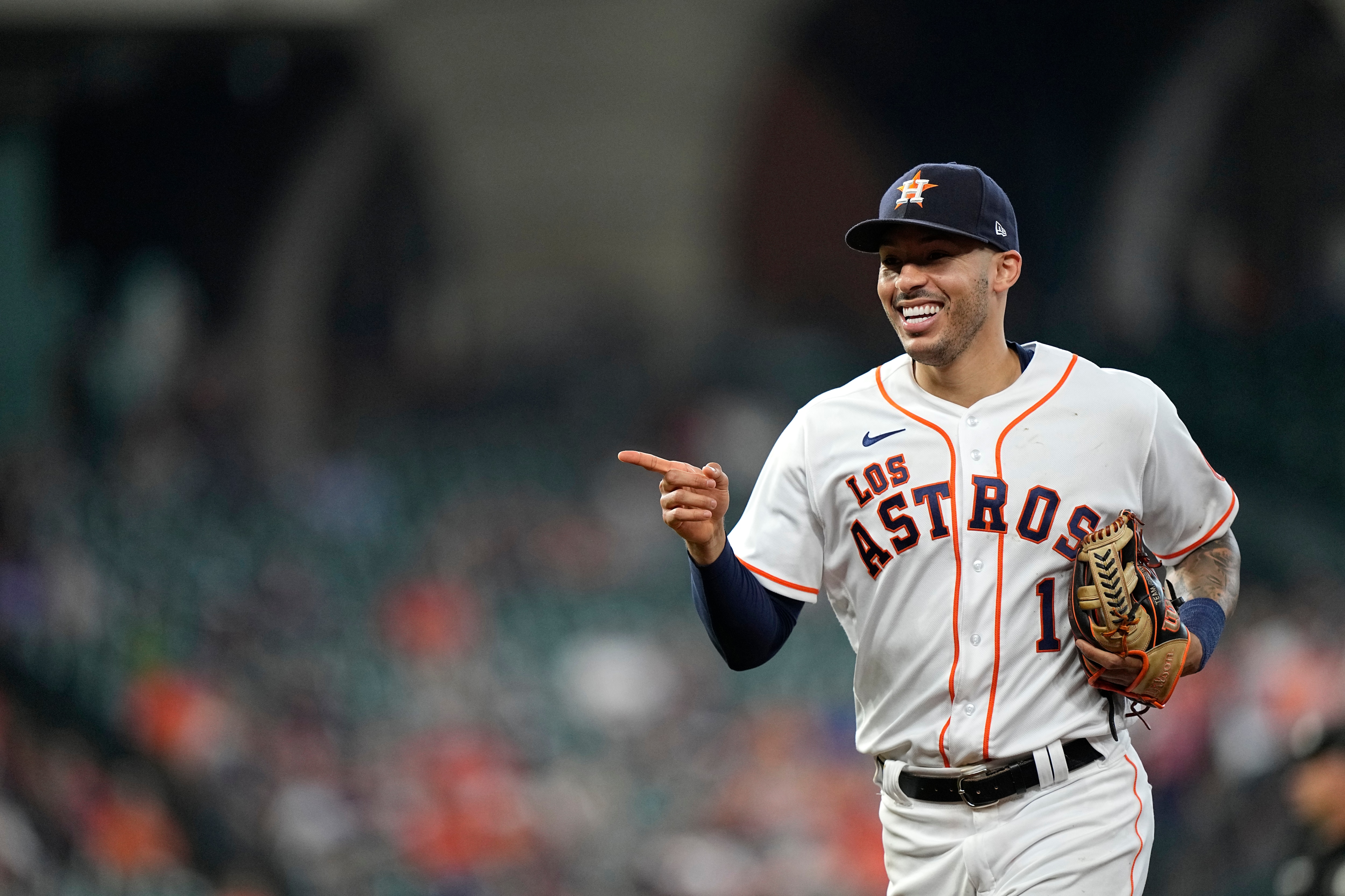 Houston Astros shortstop Carlos Correa points to first baseman Aledmys Diaz after turning a double play against the Arizona Diamondbacks during the seventh inning of a baseball game Sunday, Sept. 19, 2021, in Houston. (AP Photo/David J. Phillip)