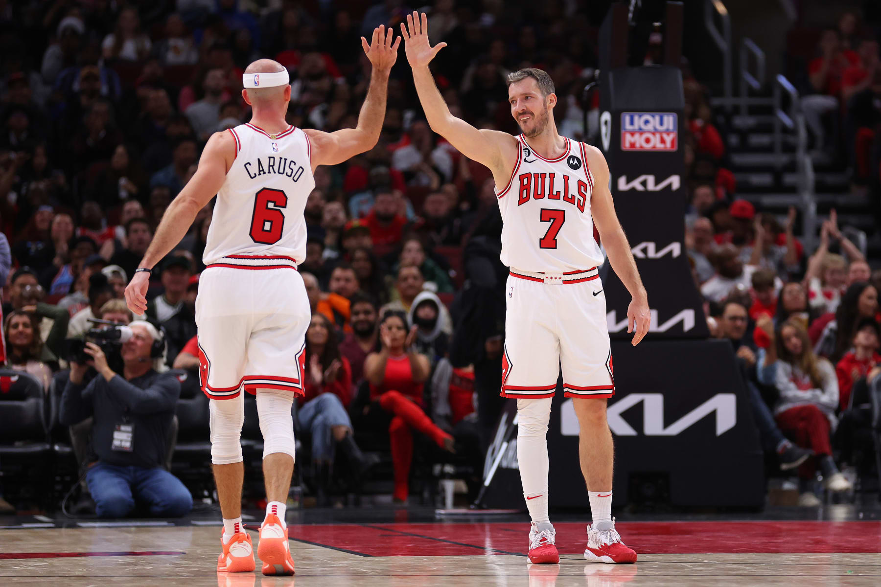CHICAGO, ILLINOIS - OCTOBER 11: Alex Caruso #6 and Goran Dragic #7 of the Chicago Bulls celebrate a basket against the Milwaukee Bucks during the second half of a preseason game at United Center on October 11, 2022 in Chicago, Illinois. NOTE TO USER: User expressly acknowledges and agrees that, by downloading and or using this photograph, User is consenting to the terms and conditions of the Getty Images License Agreement. (Photo by Michael Reaves/Getty Images)
