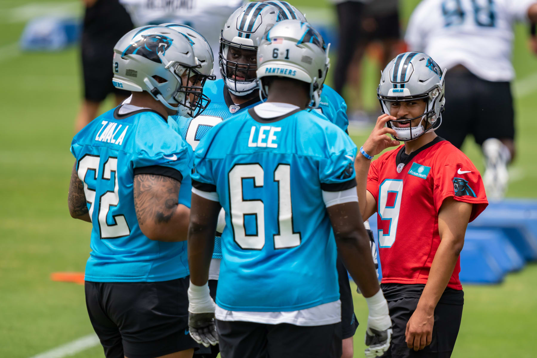 CHARLOTTE, NORTH CAROLINA - MAY 13: Bryce Young #9 of the Carolina Panthers talks with teammates before a drill during practice at Bank of America Stadium on May 13, 2023 in Charlotte, North Carolina. (Photo by Jacob Kupferman/Getty Images)
