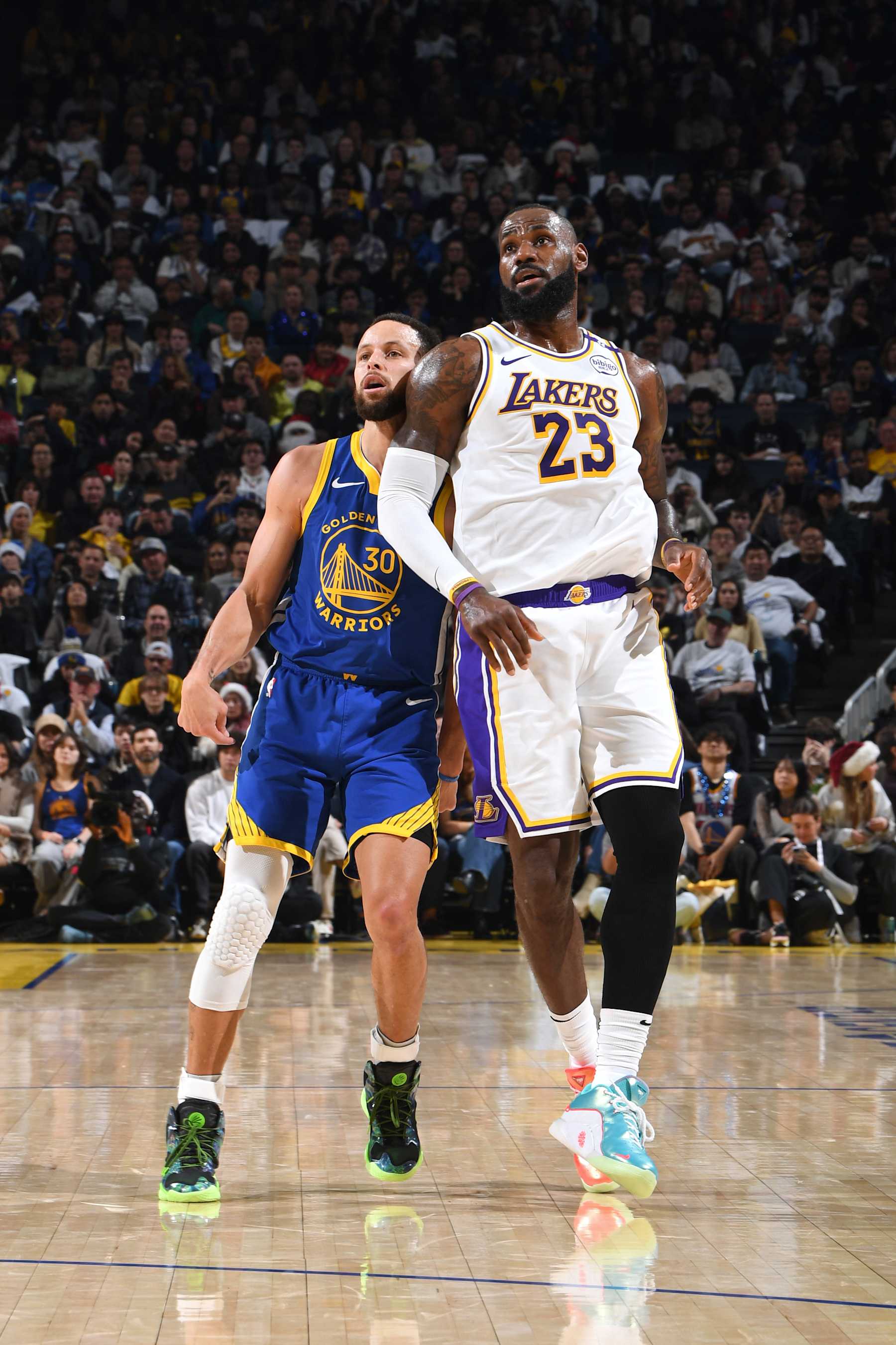 SAN FRANCISCO, CA - DECEMBER 25: Stephen Curry #30 of the Golden State Warriors and LeBron James #23 of the Los Angeles Lakers look on during the game on December 25, 2024 at Chase Center in San Francisco, California. NOTE TO USER: User expressly acknowledges and agrees that, by downloading and or using this photograph, user is consenting to the terms and conditions of Getty Images License Agreement. Mandatory Copyright Notice: Copyright 2024 NBAE (Photo by Noah Graham/NBAE via Getty Images)