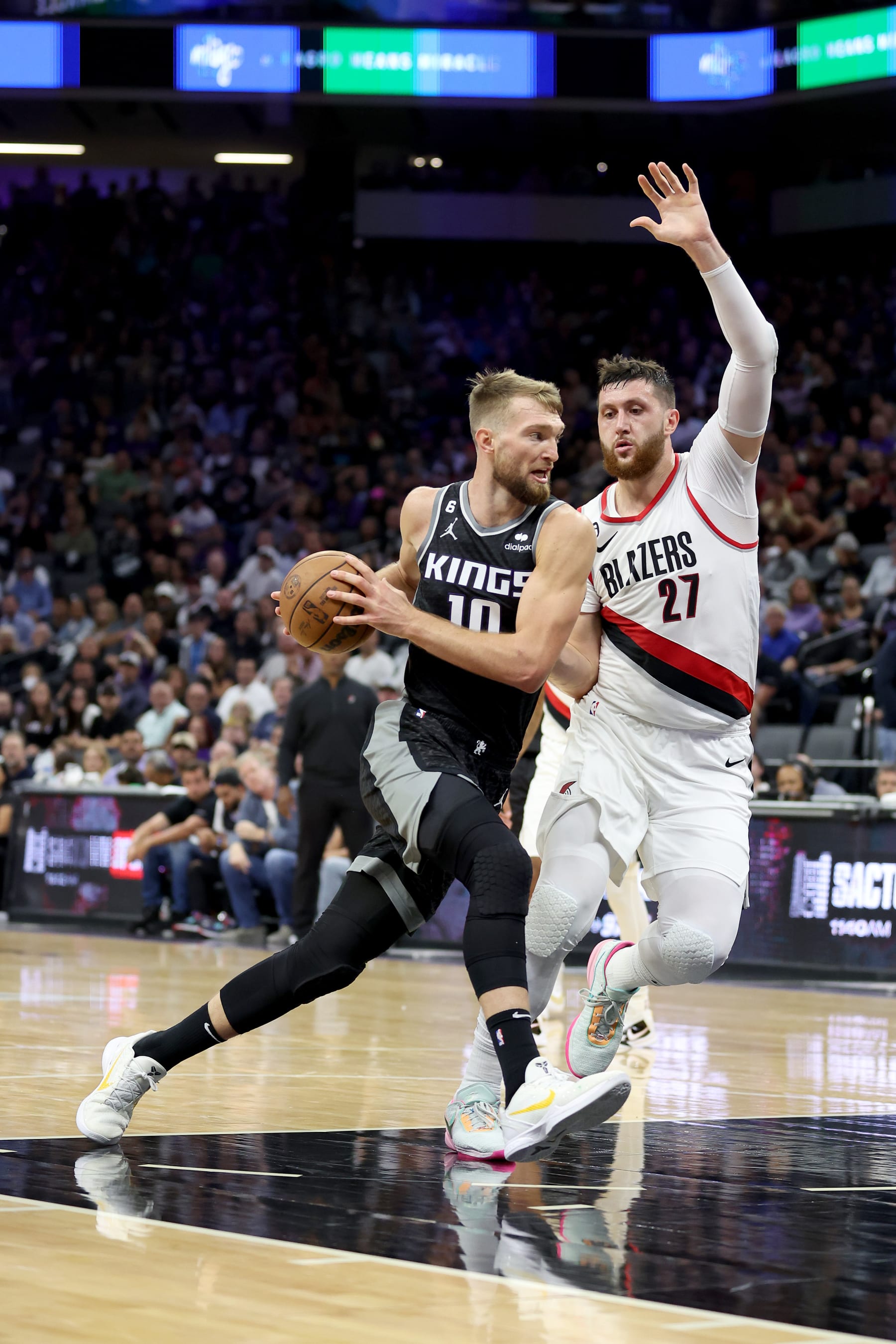 SACRAMENTO, CALIFORNIA - OCTOBER 19: Domantas Sabonis #10 of the Sacramento Kings is guarded by Jusuf Nurkic #27 of the Portland Trail Blazers at Golden 1 Center on October 19, 2022 in Sacramento, California. NOTE TO USER: User expressly acknowledges and agrees that, by downloading and or using this photograph, User is consenting to the terms and conditions of the Getty Images License Agreement.  (Photo by Ezra Shaw/Getty Images)